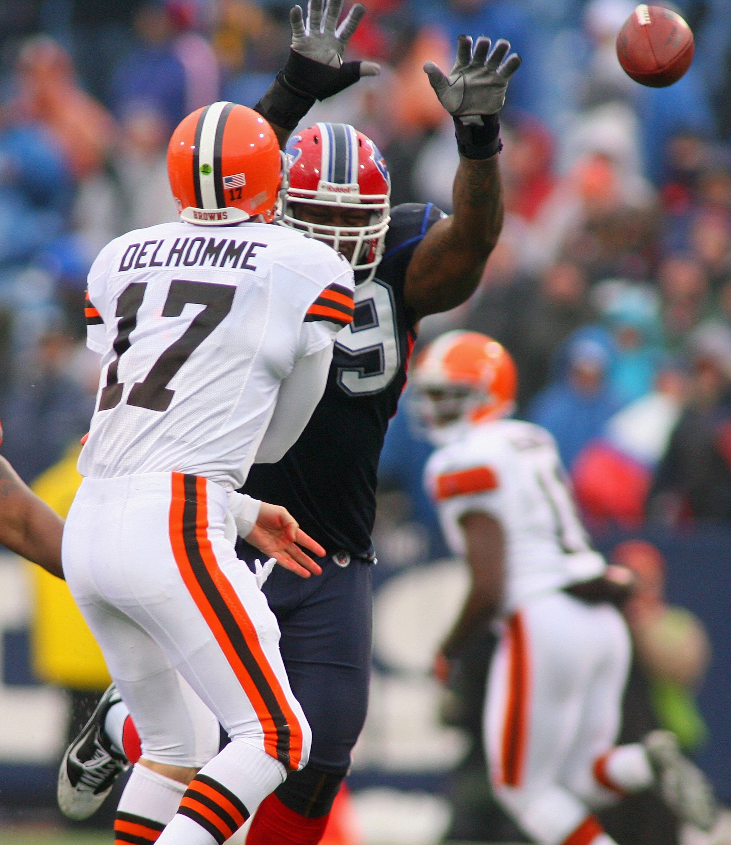 ORCHARD PARK, NY - DECEMBER 12:  Jake Delhomme #17 of the Cleveland Browns throws a pass with pressure from Marcus Stroud #99 of the Buffalo Bills  at Ralph Wilson Stadium on December 12, 2010 in Orchard Park, New York.  (Photo by Rick Stewart/Getty Image