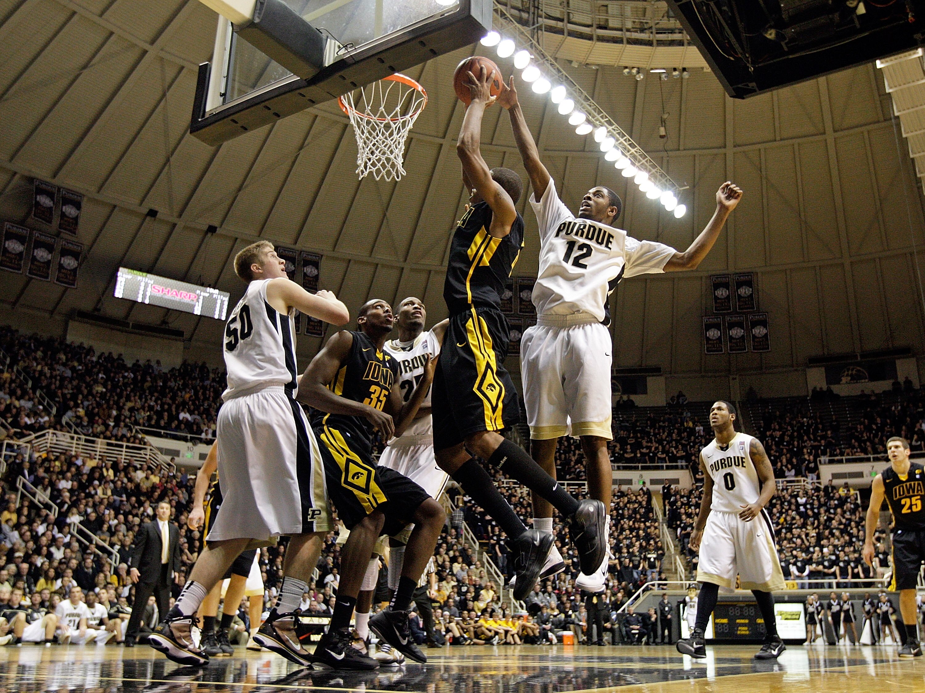 WEST LAFAYETTE, IN - JANUARY 09:  Roy Devyn Marble #4 of the Iowa Hawkeyes drives for a shot attempt against Kelsey Barlow #12 of the Purdue Boilermakers during their Big Ten Conference game at Mackey Arena on January 9, 2011 in West Lafayette, Indiana.