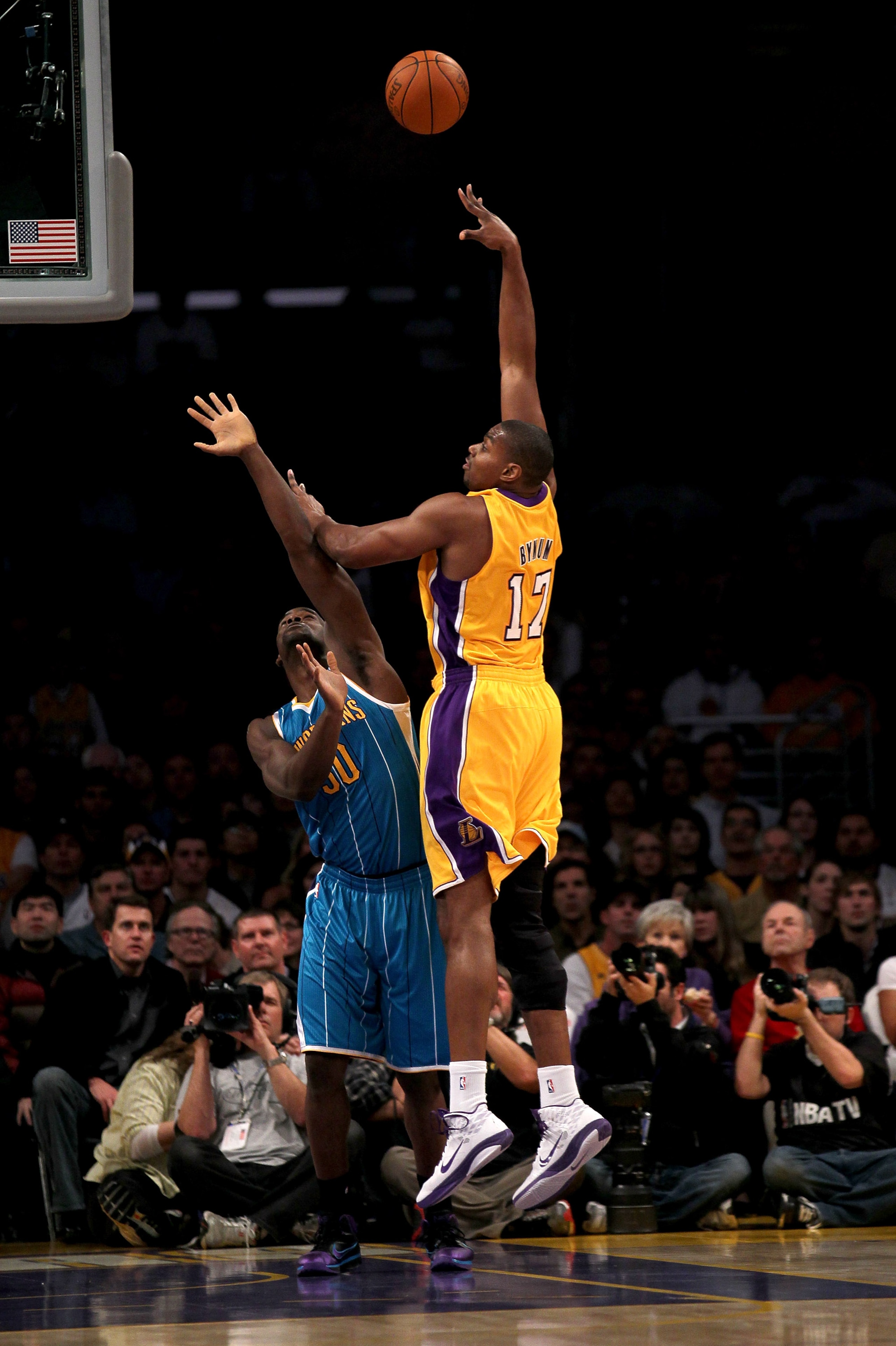 LOS ANGELES, CA - JANUARY 7:  Andrew Bynum #17 of the Los Angeles Lakers shoots over Emeka Okafor #50 of the New Orleans Hornets at Staples Center on January 7, 2011 in Los Angeles, California.  NOTE TO USER: User expressly acknowledges and agrees that, b