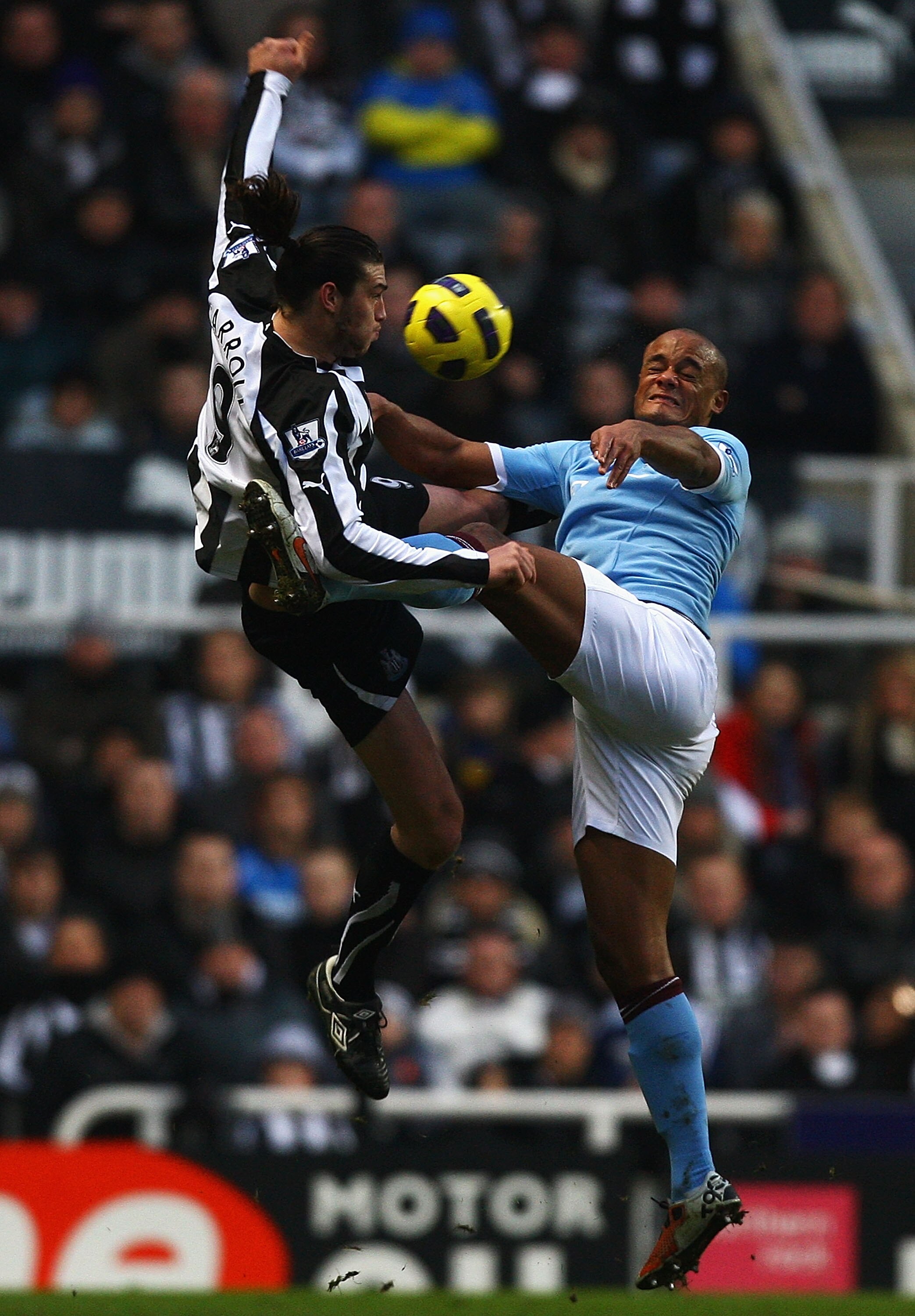 NEWCASTLE UPON TYNE, ENGLAND - DECEMBER 26:  Andy Carroll of Newcastle and Vincent Kompany of Manchester City challenge for the ball during the Barclays Premier League match between Newcastle United and Manchester City at St James' Park on December 26, 20