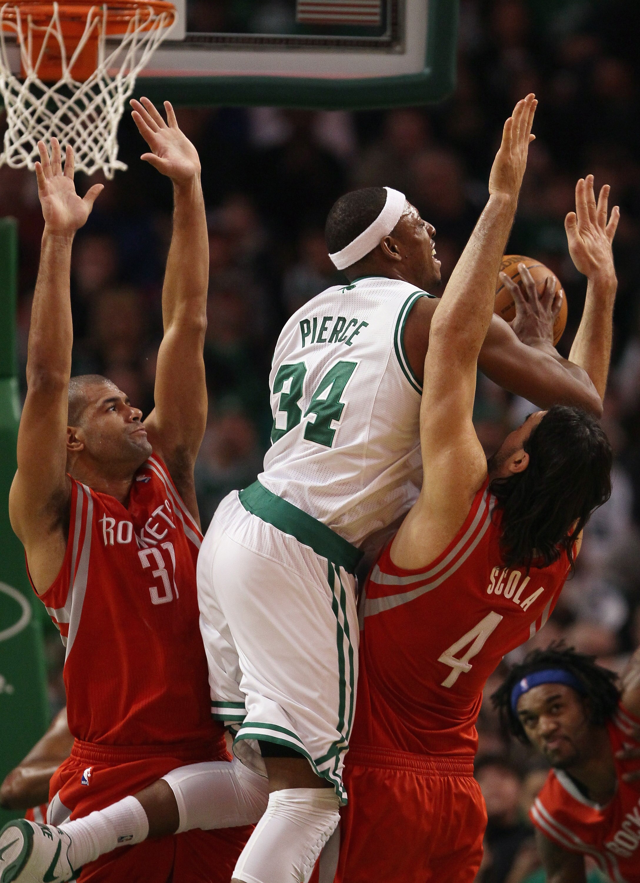 BOSTON, MA - JANUARY 10:  Paul Pierce #34 of the Boston Celtics tries to pass the ball as Shane Battier #31 and Luis Scola #4 of the Houston Rockets defend on January 10, 2011 at the TD Garden in Boston, Massachusetts.  The Rockets defeated the Celtics 10