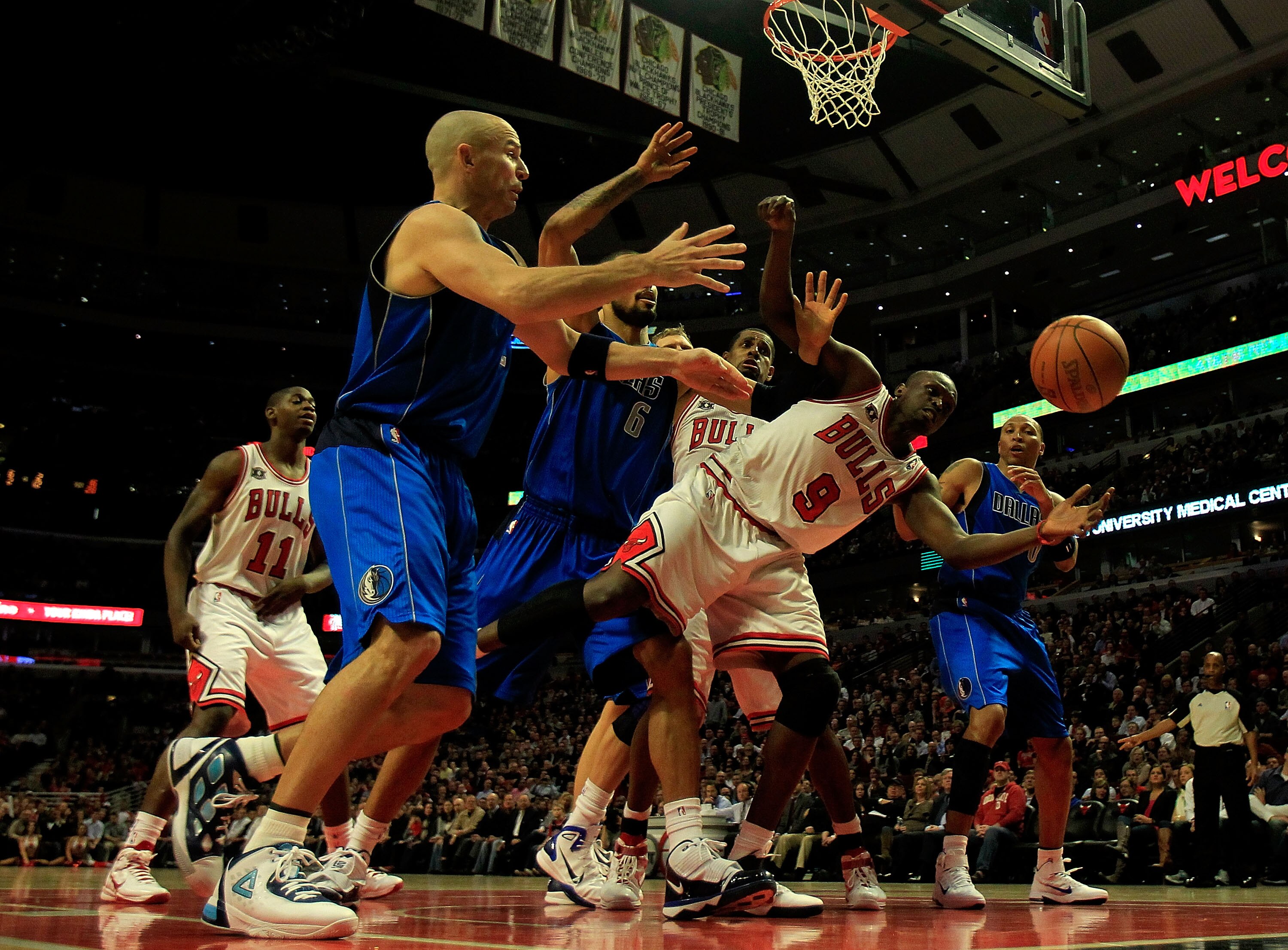 CHICAGO, IL - JANUARY 20: Loul Deng #9 of the Chicago Bulls reaches for the ball under pressure from Tyson Chandler #6 and Jason Kidd #2 of the Dallas Mavericks at the United Center on January 20, 2011 in Chicago, Illinois. The Bulls defeated the Maverick