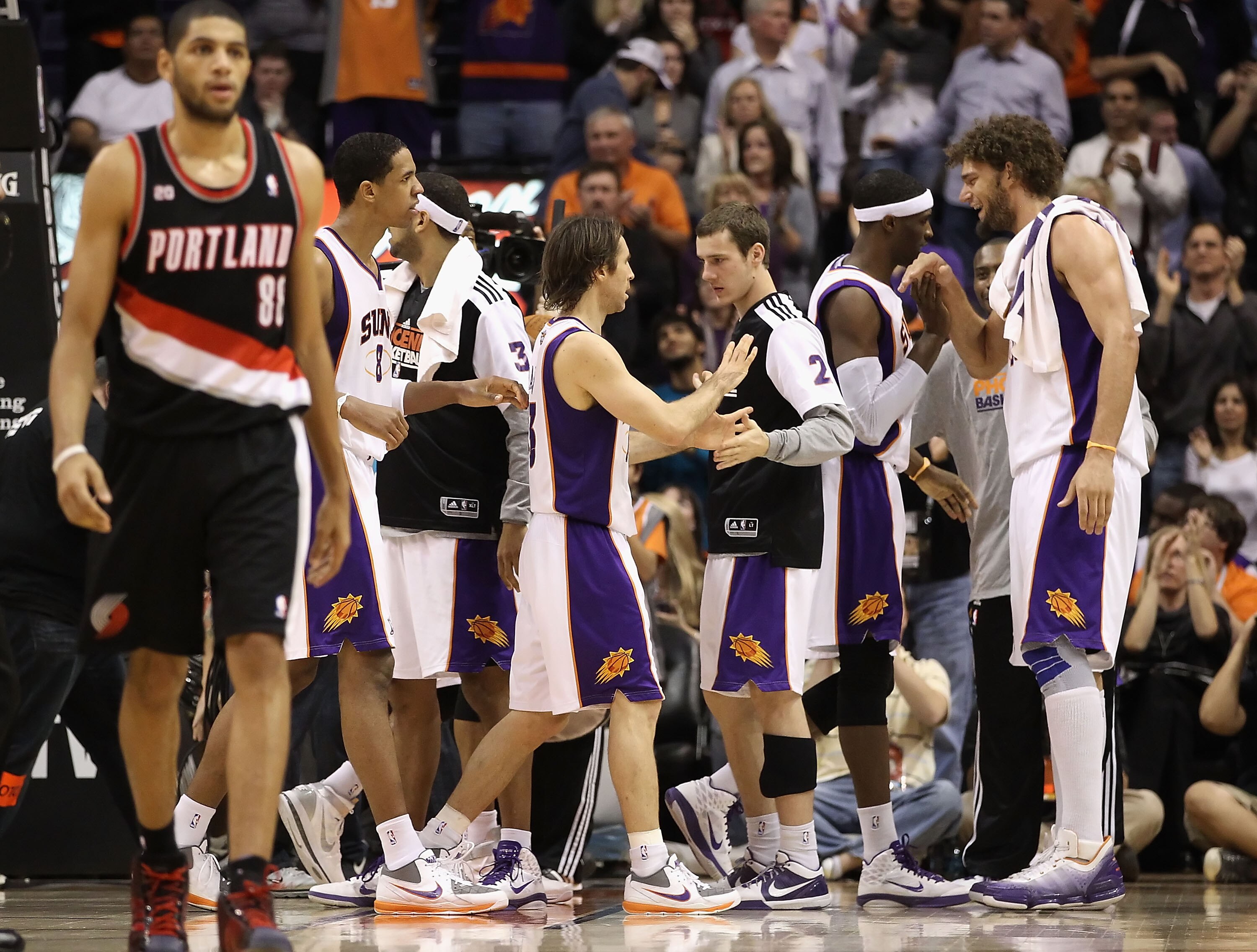 PHOENIX, AZ - JANUARY 14:  Steve Nash #13 of the Phoenix Suns high fives teammate Goran Dragic #2 after scoring against the Portland Trail Blazers during the NBA game at US Airways Center on January 14, 2011 in Phoenix, Arizona. The Suns defeated the 115-