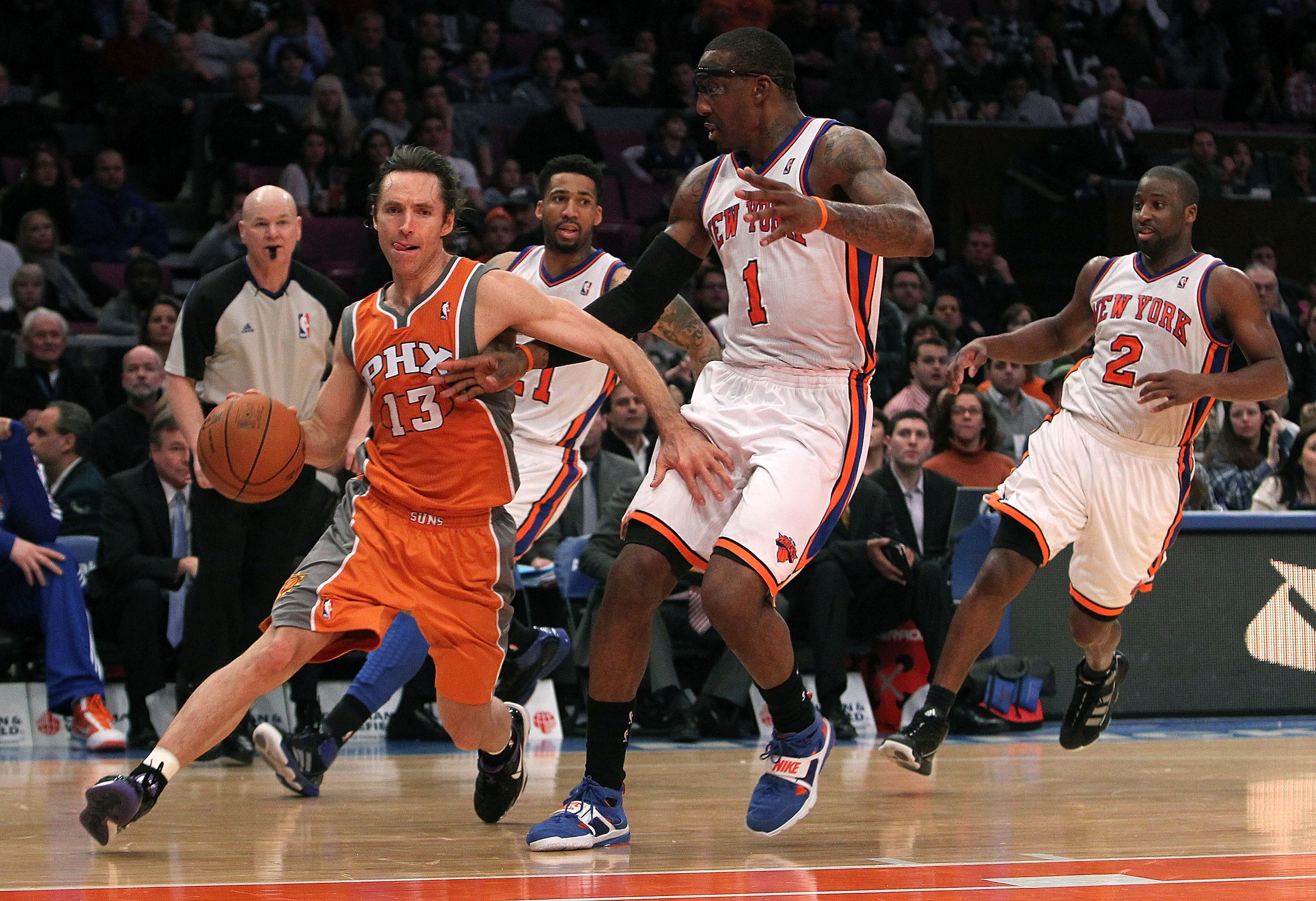 NEW YORK, NY - JANUARY 17:  Steve Nash #13 of the Phoenix Suns drives to the basket against Amar'e Stoudemire #1 of the New York Knicks at Madison Square Garden on January 17, 2011 in New York City. NOTE TO USER: User expressly acknowledges and agrees tha