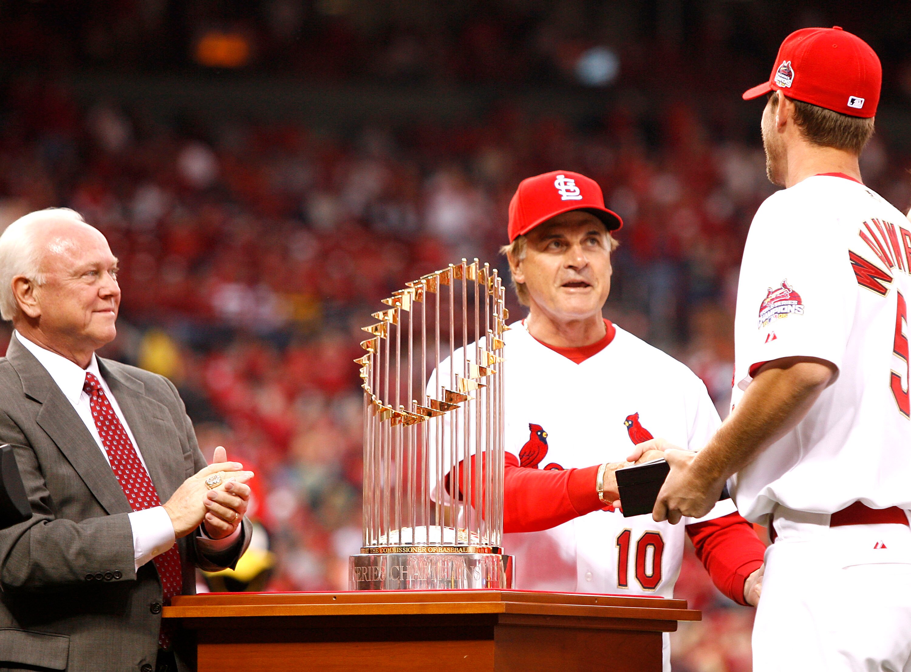 ST. LOUIS, MO - APRIL 3: Adam Wainwright #50 of the St. Louis Cardinals is presented with his 2006 World Series Championship ring by manager Tony LaRussa #10 as G.M. Walt Jocketty looks on before playing the New York Mets at Busch Stadium April 3, 2007 i ST. LOUIS, MO - APRIL 3: Adam Wainwright #50 of the St. Louis Cardinals is presented with his 2006 World Series Championship ring by manager Tony LaRussa #10 as G.M. Walt Jocketty looks on before playing the New York Mets at Busch Stadium April 3, 2007 i