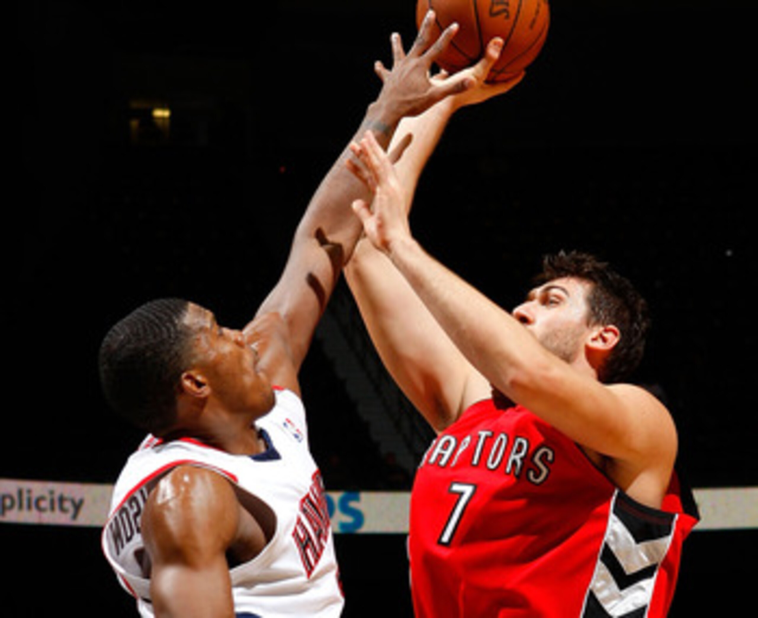 ATLANTA - DECEMBER 02:  Joe Johnson #2 of the Atlanta Hawks defends a shot by Andrea Bargnani #7 of the Toronto Raptors at Philips Arena on December 2, 2009 in Atlanta, Georgia.  NOTE TO USER: User expressly acknowledges and agrees that, by downloading an
