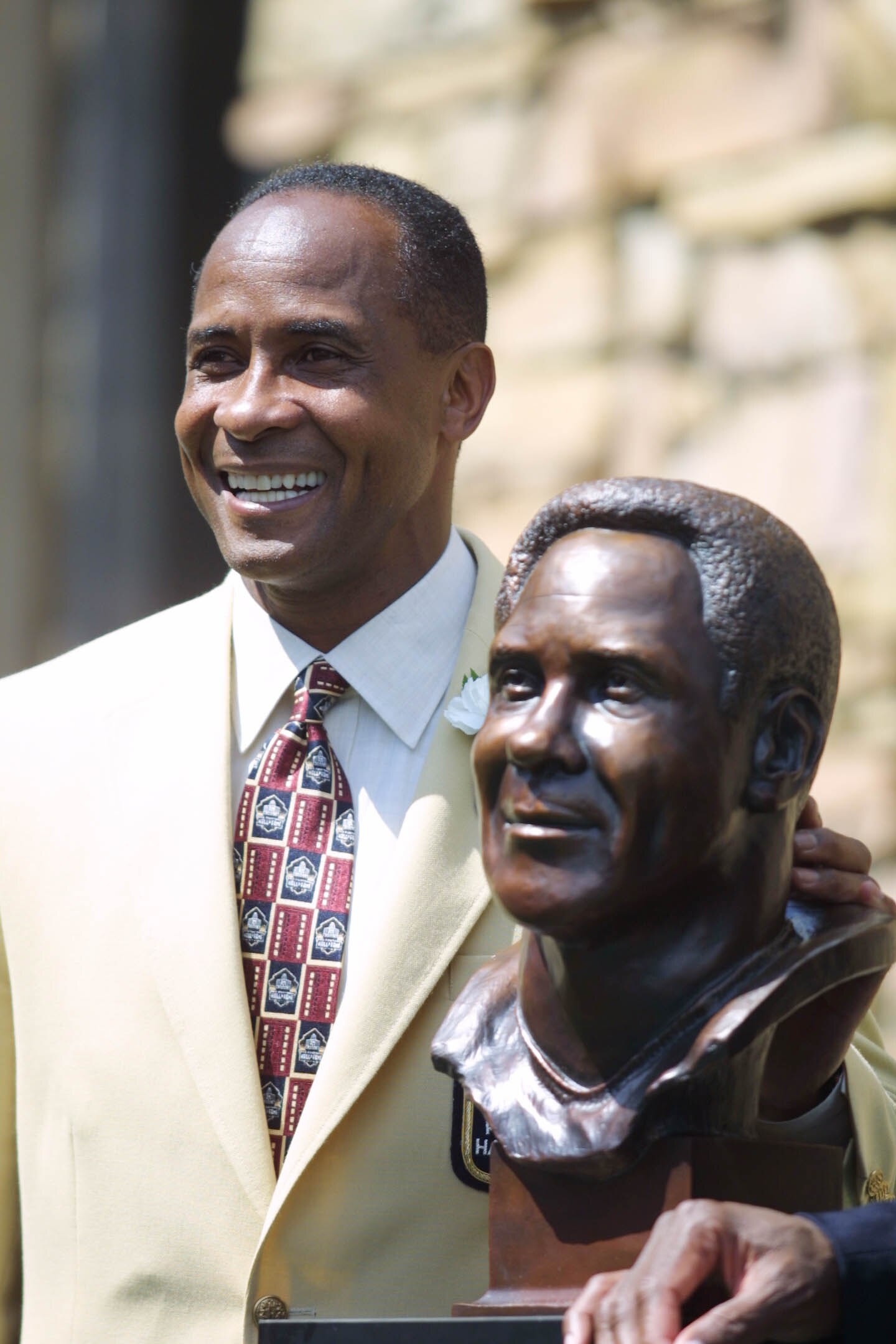 04 Aug 2001 : Lynn Swann poses next to his bust during the 2001 Pro Football Hall Of Fame Induction Ceremony at Hall's Game Day Theater in Canton, Ohio. DIGITAL IMAGE.Mandatory Credit: Tom Pidgeon/Allsport