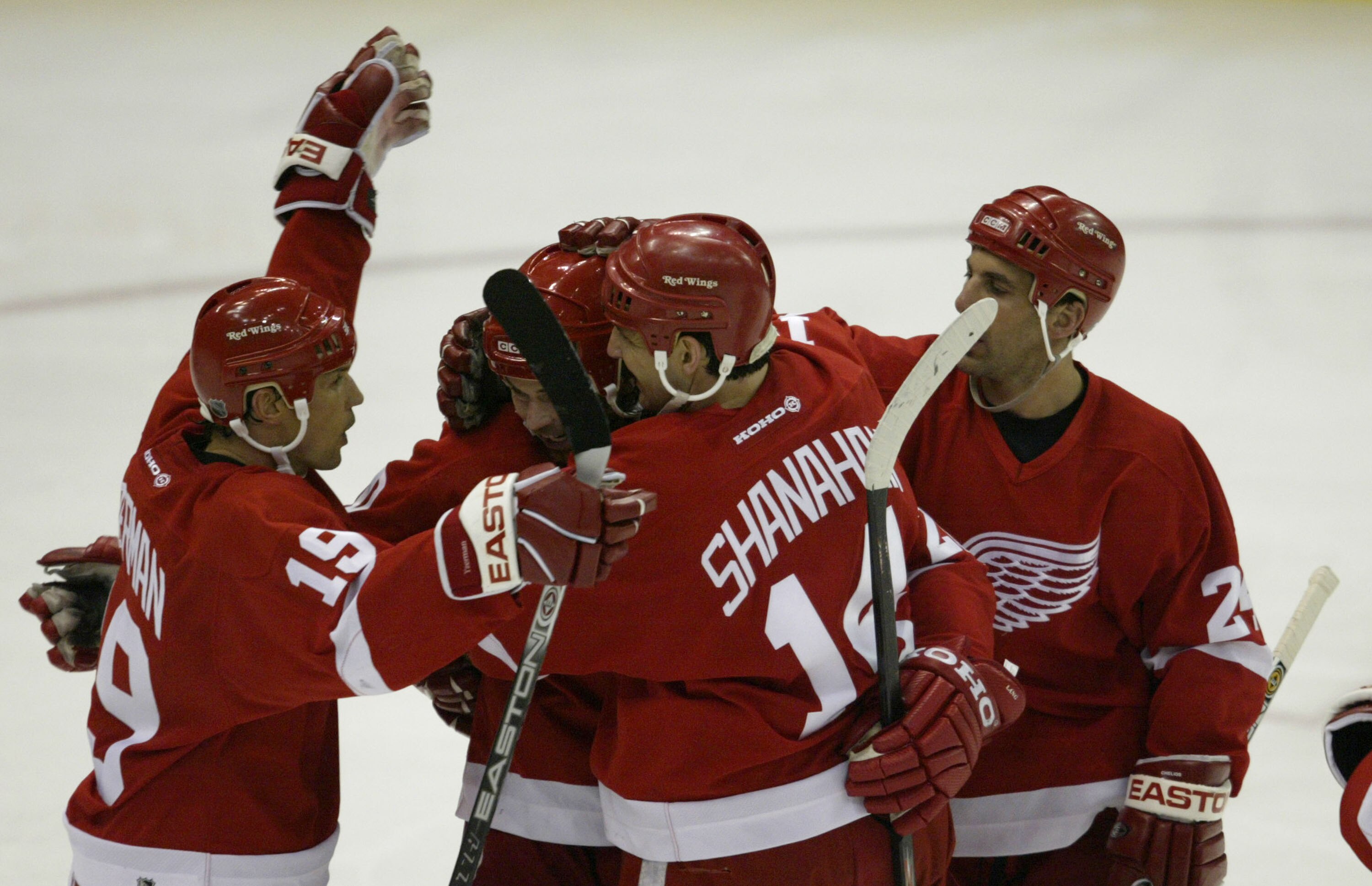 DETROIT - APRIL 22: Steve Yzerman #19 of the Detroit Red Wings congratulates teammate Robert Lang #20 on his second period goal with teammates Brendan Shanahan #14 and Chris Chelios #24 against the Calgary Flames during Game one of the Conference Semifin DETROIT - APRIL 22: Steve Yzerman #19 of the Detroit Red Wings congratulates teammate Robert Lang #20 on his second period goal with teammates Brendan Shanahan #14 and Chris Chelios #24 against the Calgary Flames during Game one of the Conference Semifin