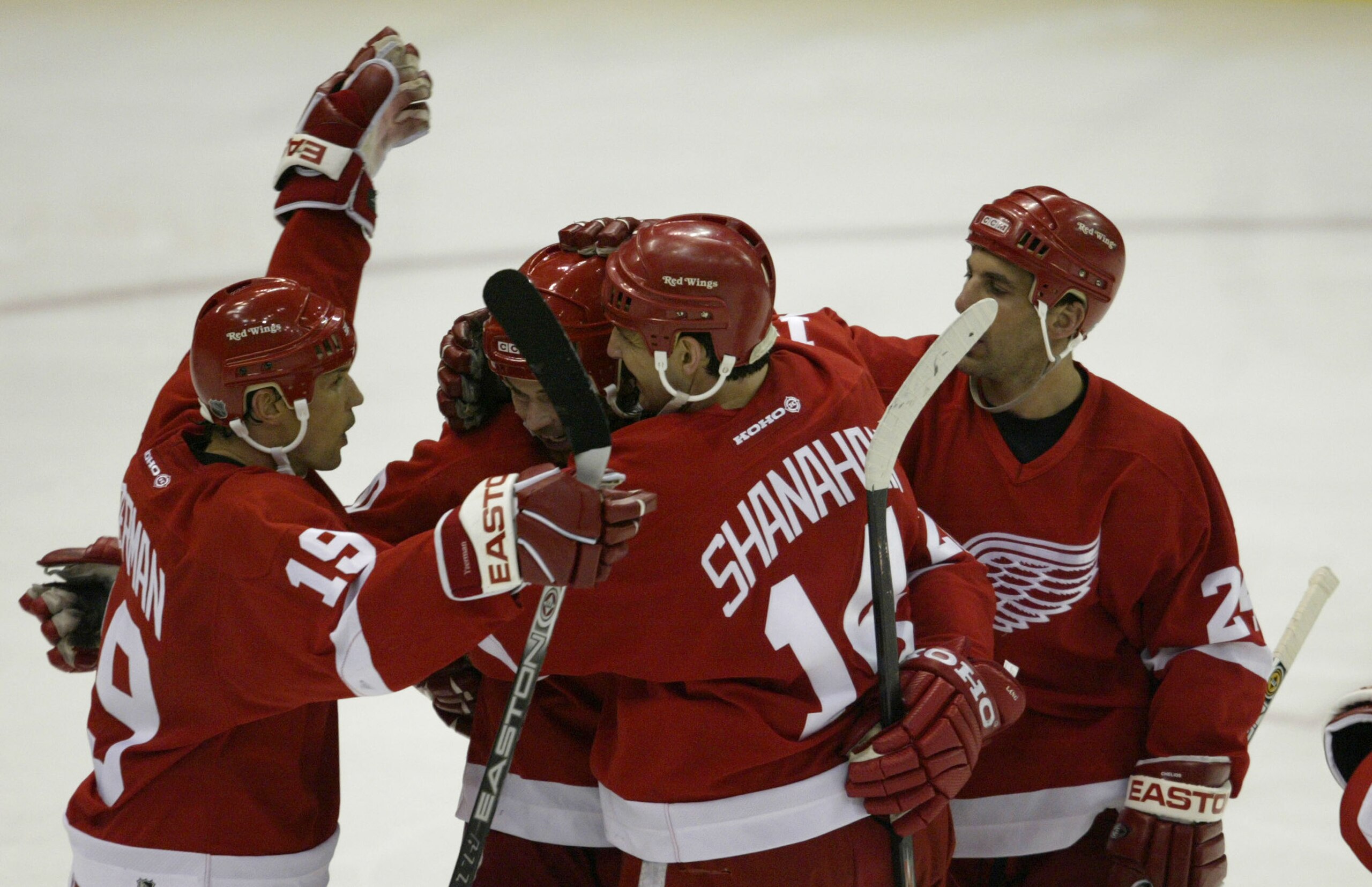 DETROIT - APRIL 22: Steve Yzerman #19 of the Detroit Red Wings congratulates teammate Robert Lang #20 on his second period goal with teammates Brendan Shanahan #14 and Chris Chelios #24 against the Calgary Flames during Game one of the Conference Semifin DETROIT - APRIL 22: Steve Yzerman #19 of the Detroit Red Wings congratulates teammate Robert Lang #20 on his second period goal with teammates Brendan Shanahan #14 and Chris Chelios #24 against the Calgary Flames during Game one of the Conference Semifin