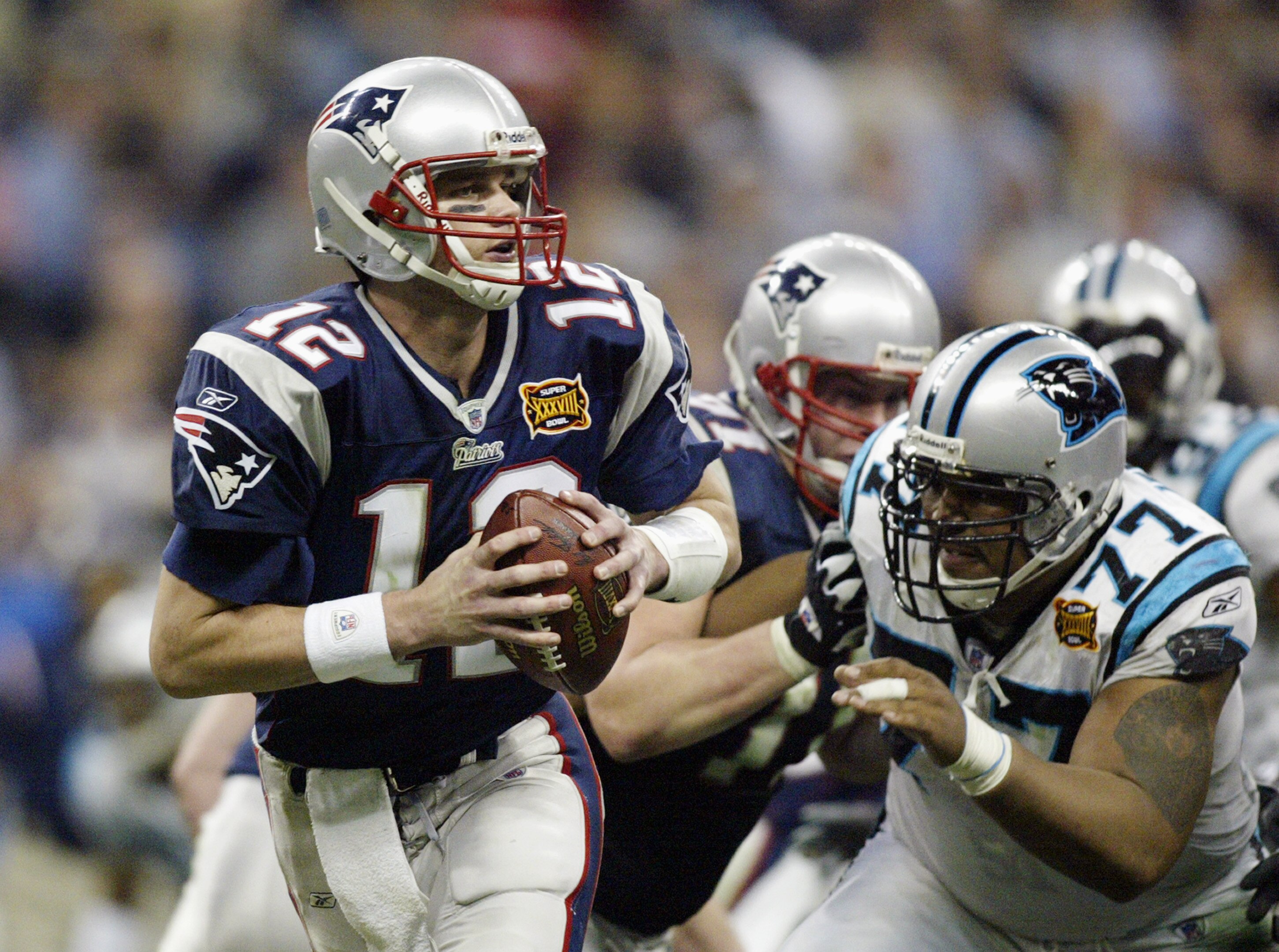 HOUSTON, TX - FEBRUARY 1:  Quarterback Tom Brady #12 of the New England Patriots with the ball against the Carolina Panthers during Super Bowl XXXVIII at Reliant Stadium on February 1, 2004 in Houston, Texas. The Patriots won 32-29 to claim their second S