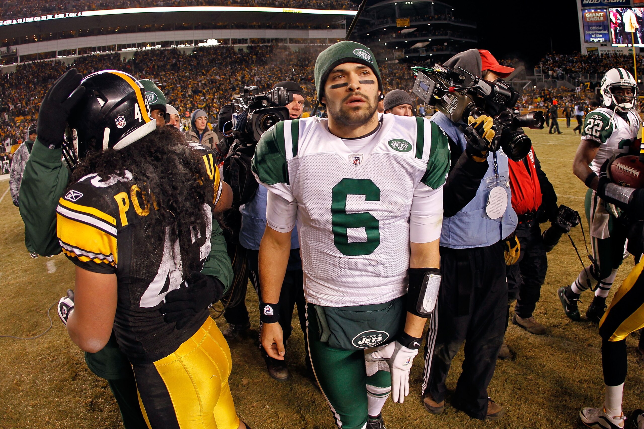 PITTSBURGH, PA - JANUARY 23: Mark Sanchez #6 of the New York Jets leaves the field as Troy Polamalu #43 of the Pittsburgh Steelers looks on after the Pittsburgh Steelers defeated the New York Jets 24 to 19 in their 2011 AFC Championship game at Heinz Fie PITTSBURGH, PA - JANUARY 23: Mark Sanchez #6 of the New York Jets leaves the field as Troy Polamalu #43 of the Pittsburgh Steelers looks on after the Pittsburgh Steelers defeated the New York Jets 24 to 19 in their 2011 AFC Championship game at Heinz Fie