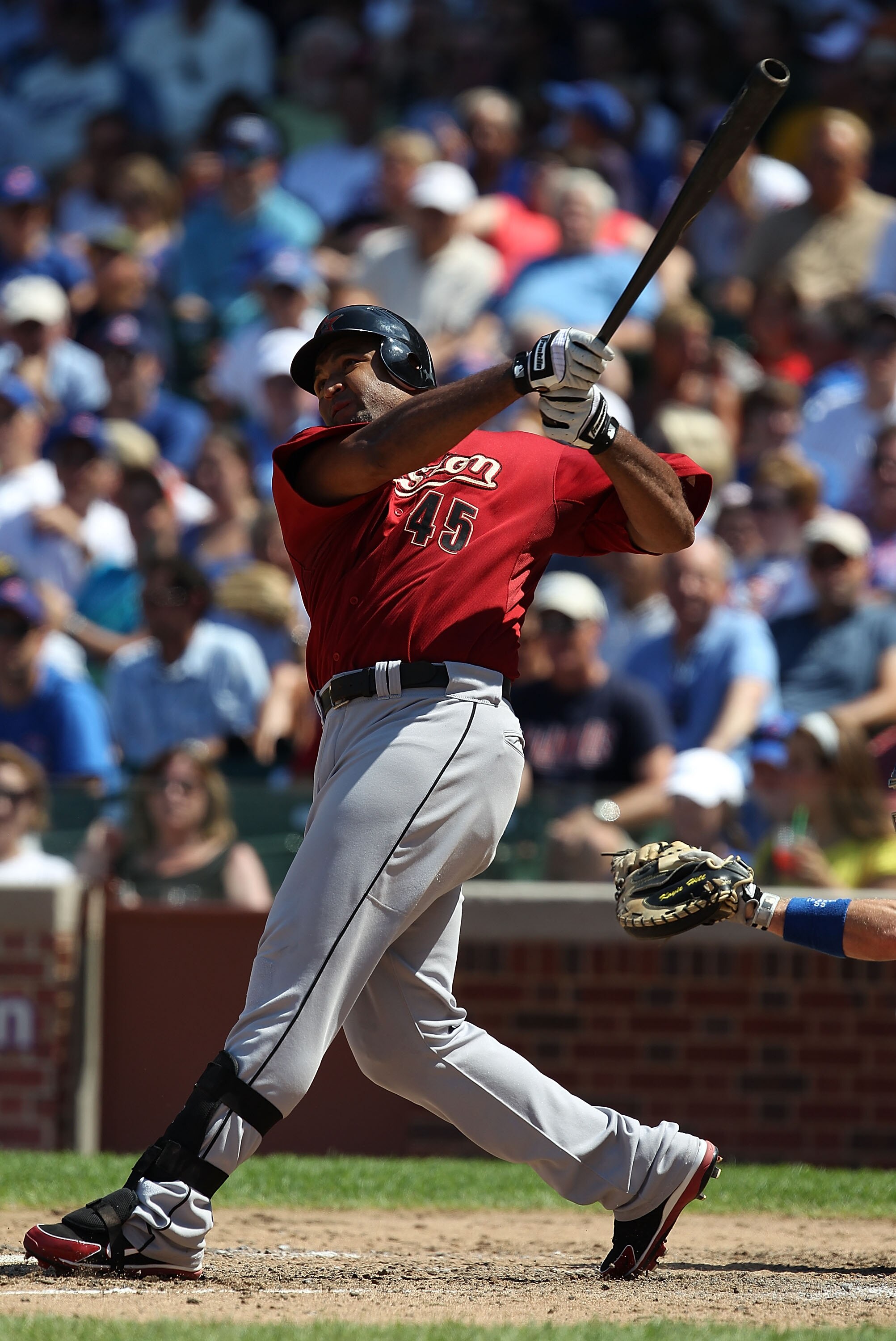 CHICAGO - JULY 21: Carlos Lee #45 of the Houston Astros hits the ball against the Chicago Cubs at Wrigley Field on July 21, 2010 in Chicago, Illinois. The Astros defeated the Cubs 4-3 in 12 innings. (Photo by Jonathan Daniel/Getty Images)