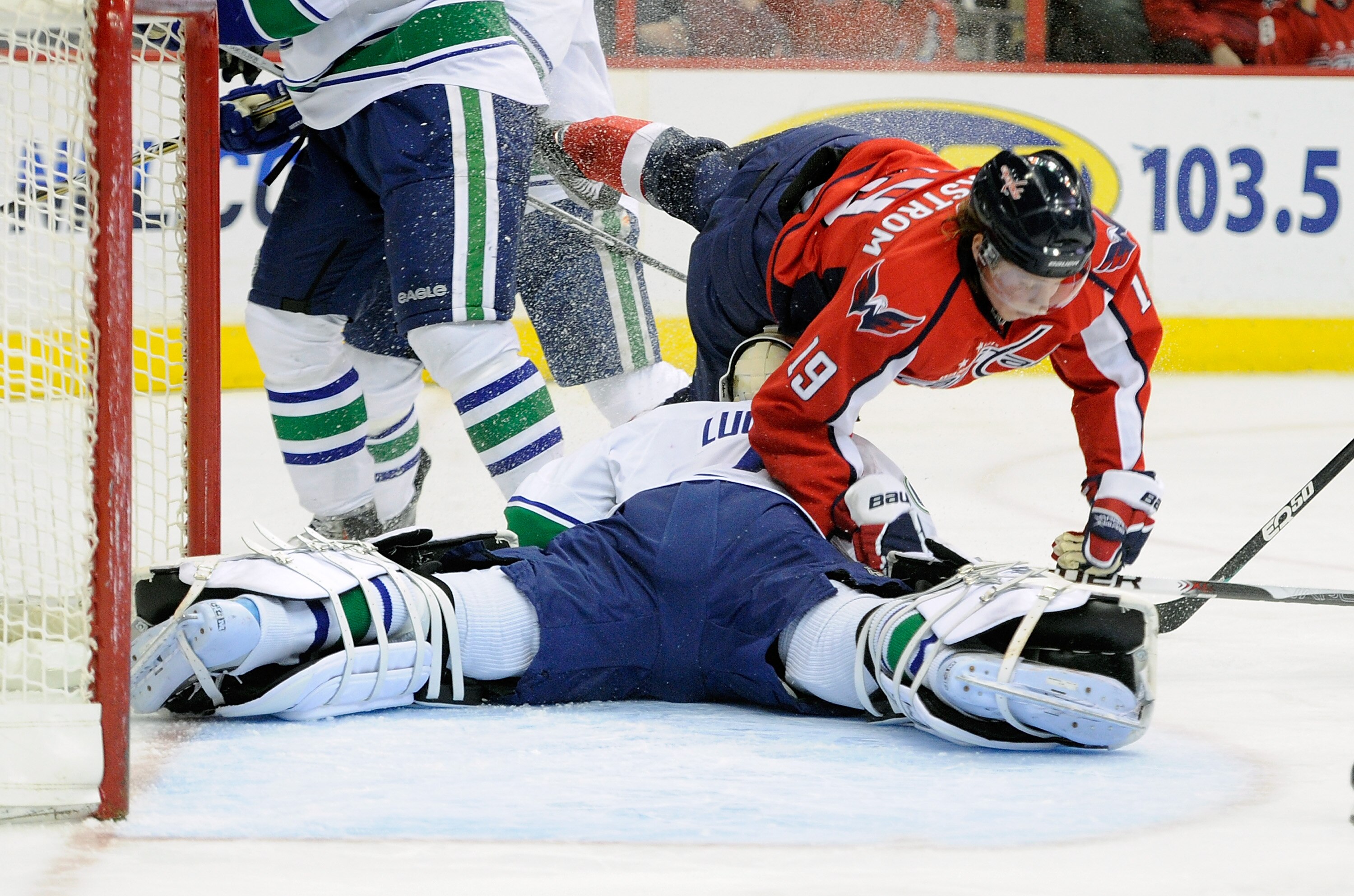 WASHINGTON - JANUARY 14:  Nicklas Backstrom #19 of the Washington Capitals crashes into Roberto Luongo #1 of the Vancouver Canucks at the Verizon Center on January 14, 2011 in Washington, DC.  (Photo by Greg Fiume/Getty Images)