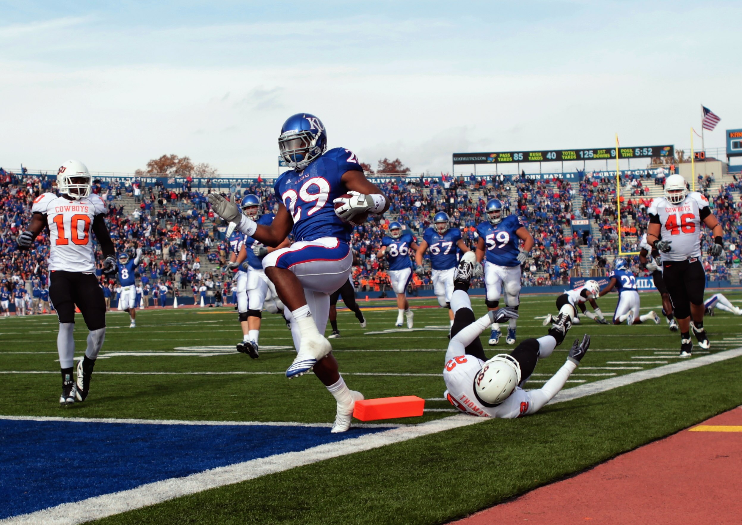 LAWRENCE, KS - NOVEMBER 20:  Running back James Sims #29 of the Kansas Jayhawks carries the ball in for a touchdown during the game against the Oklahoma State Cowboys on November 20, 2010 at Memorial Stadium in Lawrence, Kansas.  (Photo by Jamie Squire/Ge