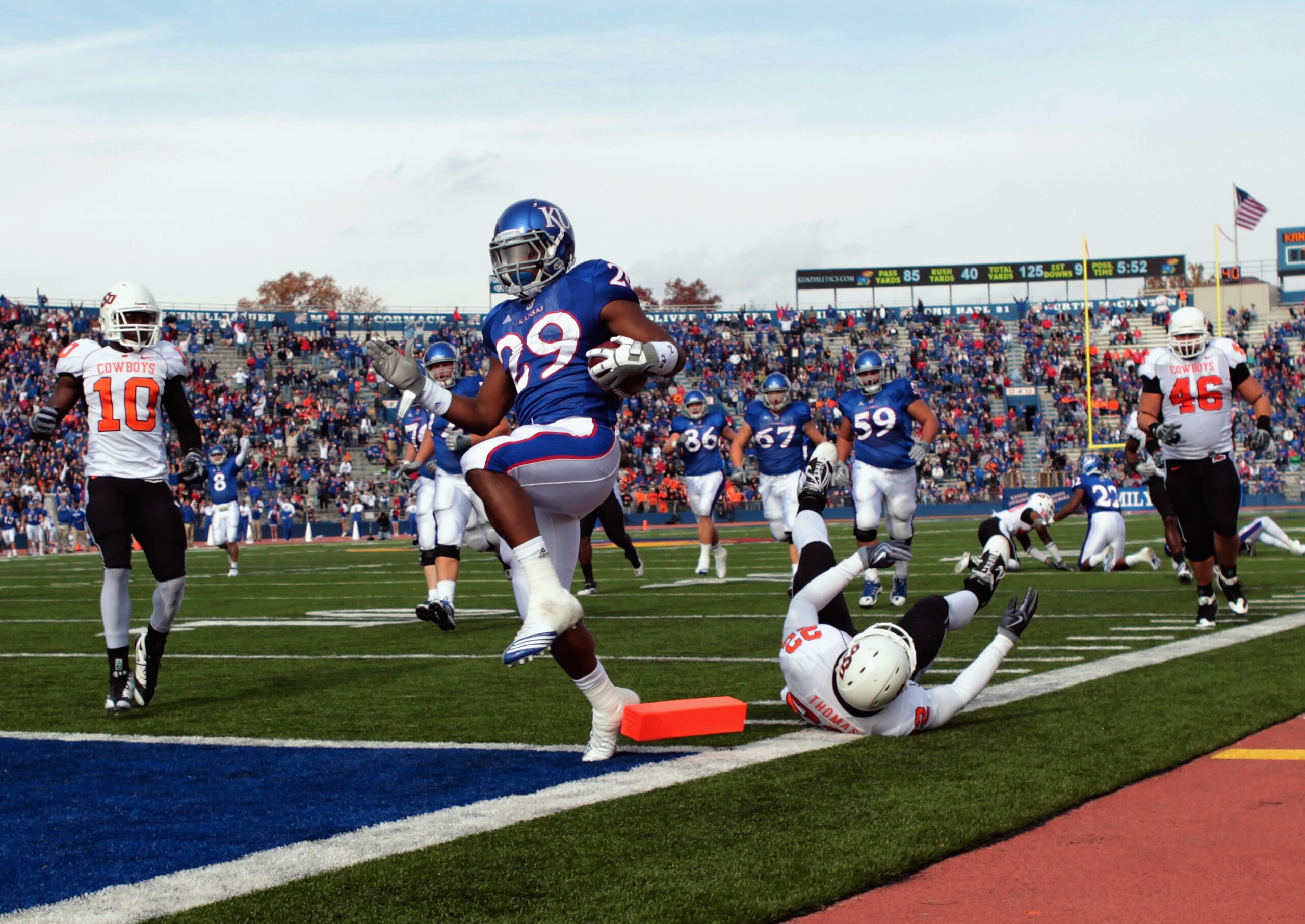 LAWRENCE, KS - NOVEMBER 20:  Running back James Sims #29 of the Kansas Jayhawks carries the ball in for a touchdown during the game against the Oklahoma State Cowboys on November 20, 2010 at Memorial Stadium in Lawrence, Kansas.  (Photo by Jamie Squire/Ge