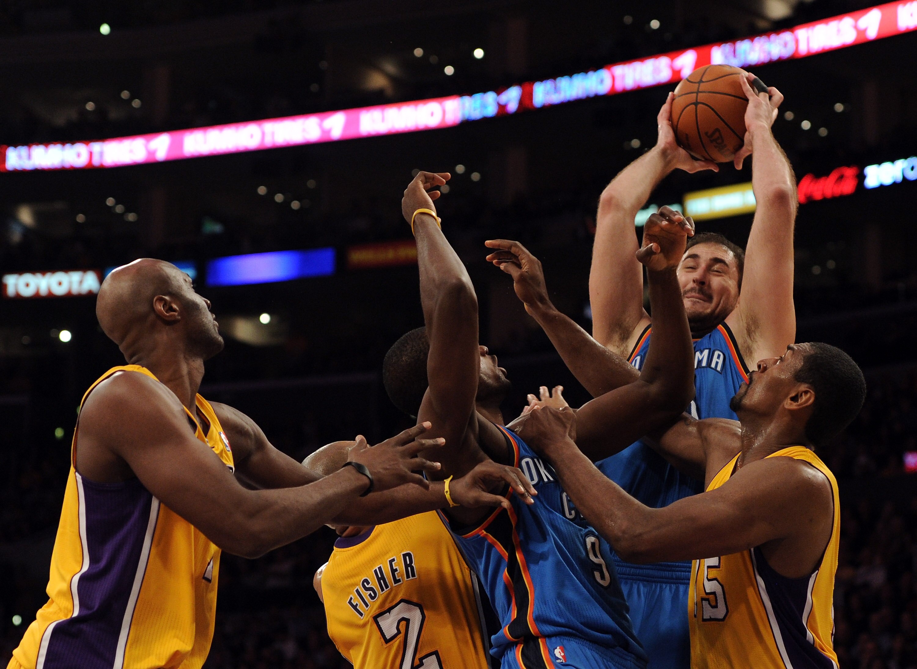 LOS ANGELES, CA - JANUARY 17:  Nenad Krstic #12 of the Oklahoma City Thunder grabs a rebound in front of Ron Artest #15 and Lamar Odom #7 of the Los Angeles Lakers at the Staples Center on January 17, 2011 in Los Angeles, California.  (Photo by Harry How/