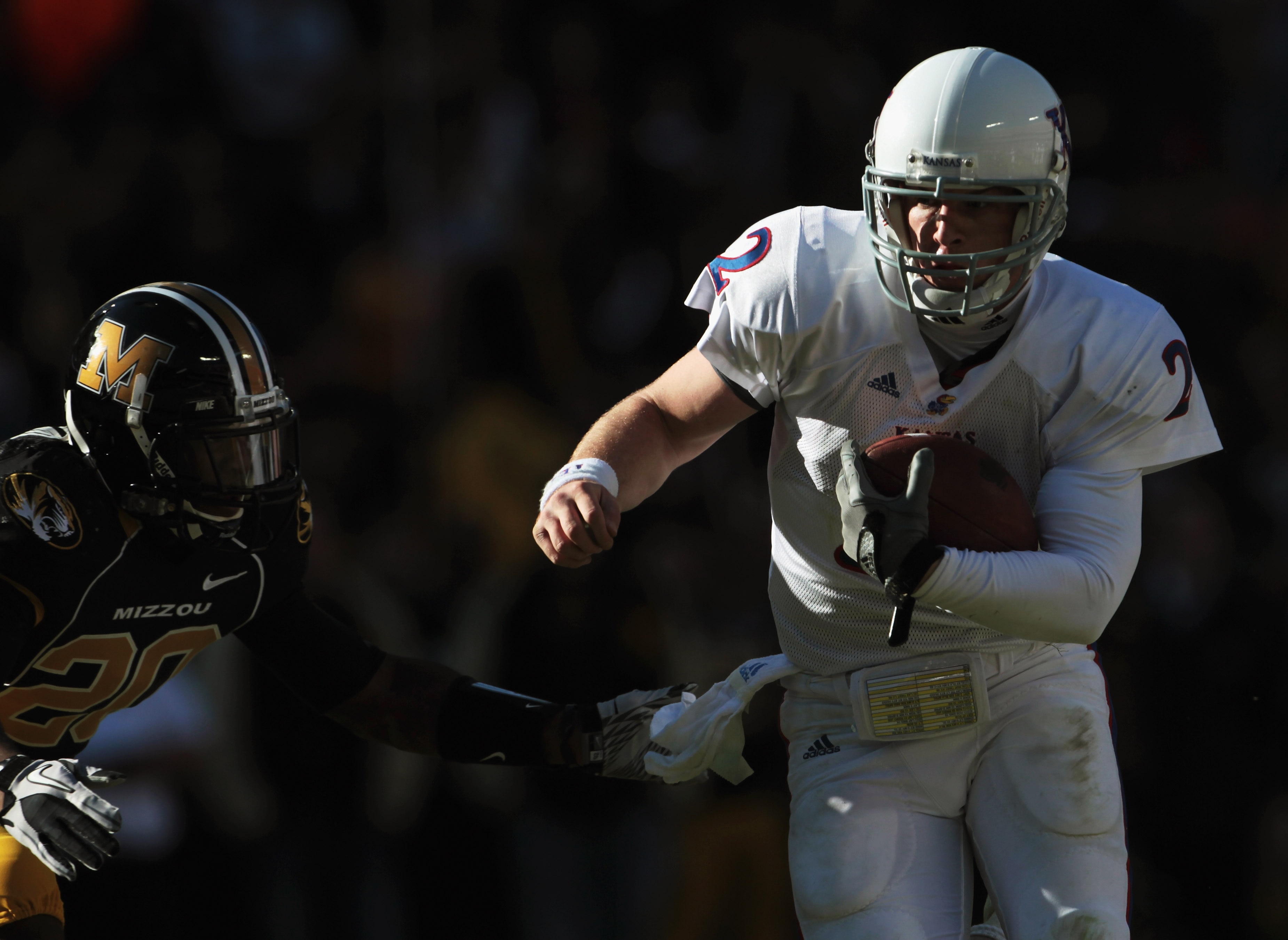 KANSAS CITY, MO - NOVEMBER 27:  Quarterback Jordan Webb #2 of the Kansas Jayhawks carries the ball into the endzone for a touchdown as Kevin Rutland #20 of the Missouri Tigers defends during the game on November 27, 2010 at Arrowhead Stadium in Kansas Cit