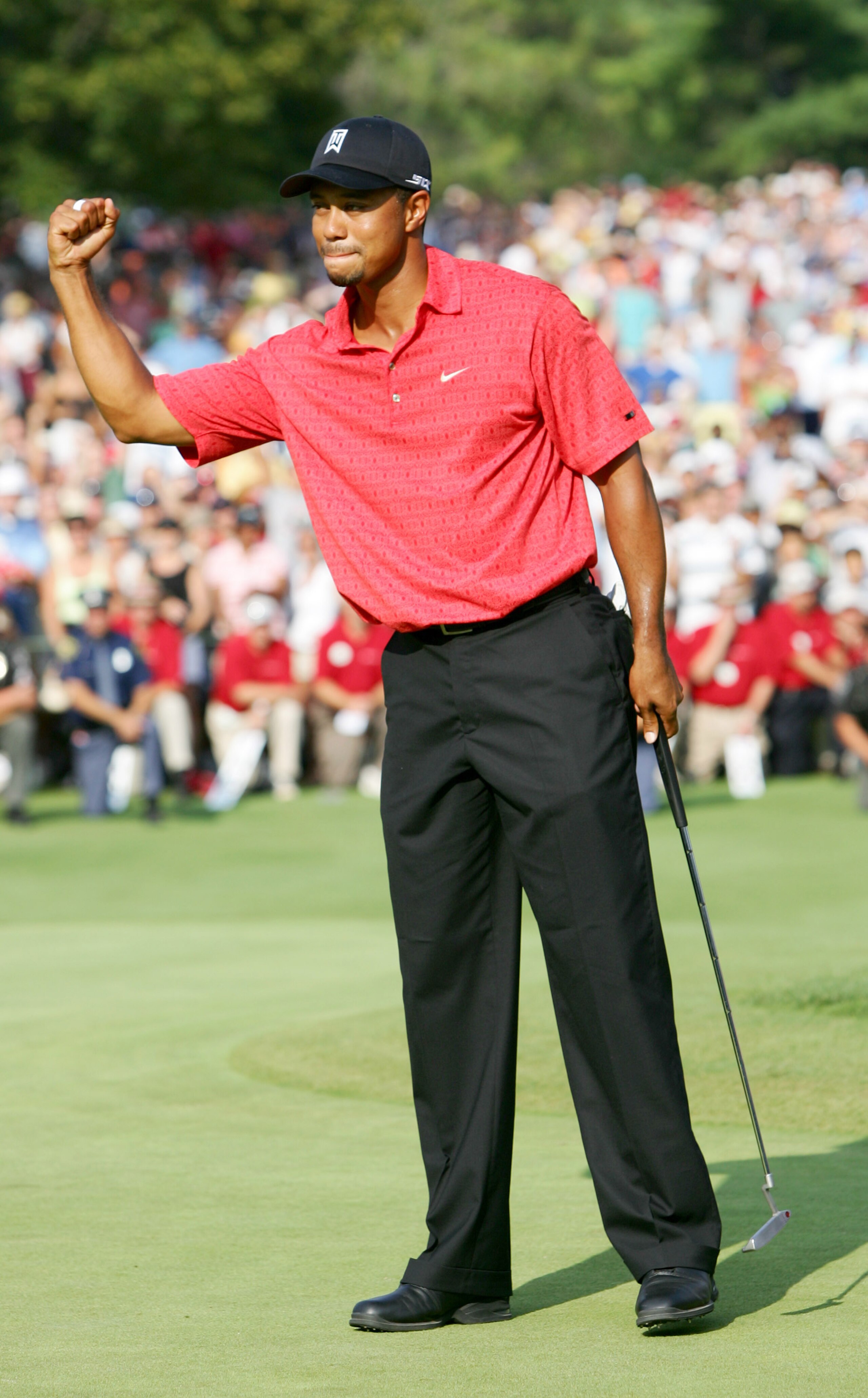 UNITED STATES - AUGUST 06:  Tiger Woods celebrates his win at the the Buick Open at Warwick Hills Golf and Country Club in Grand Blanc, Michigan on August 6, 2006.  (Photo by Sam Greenwood/Getty Images)