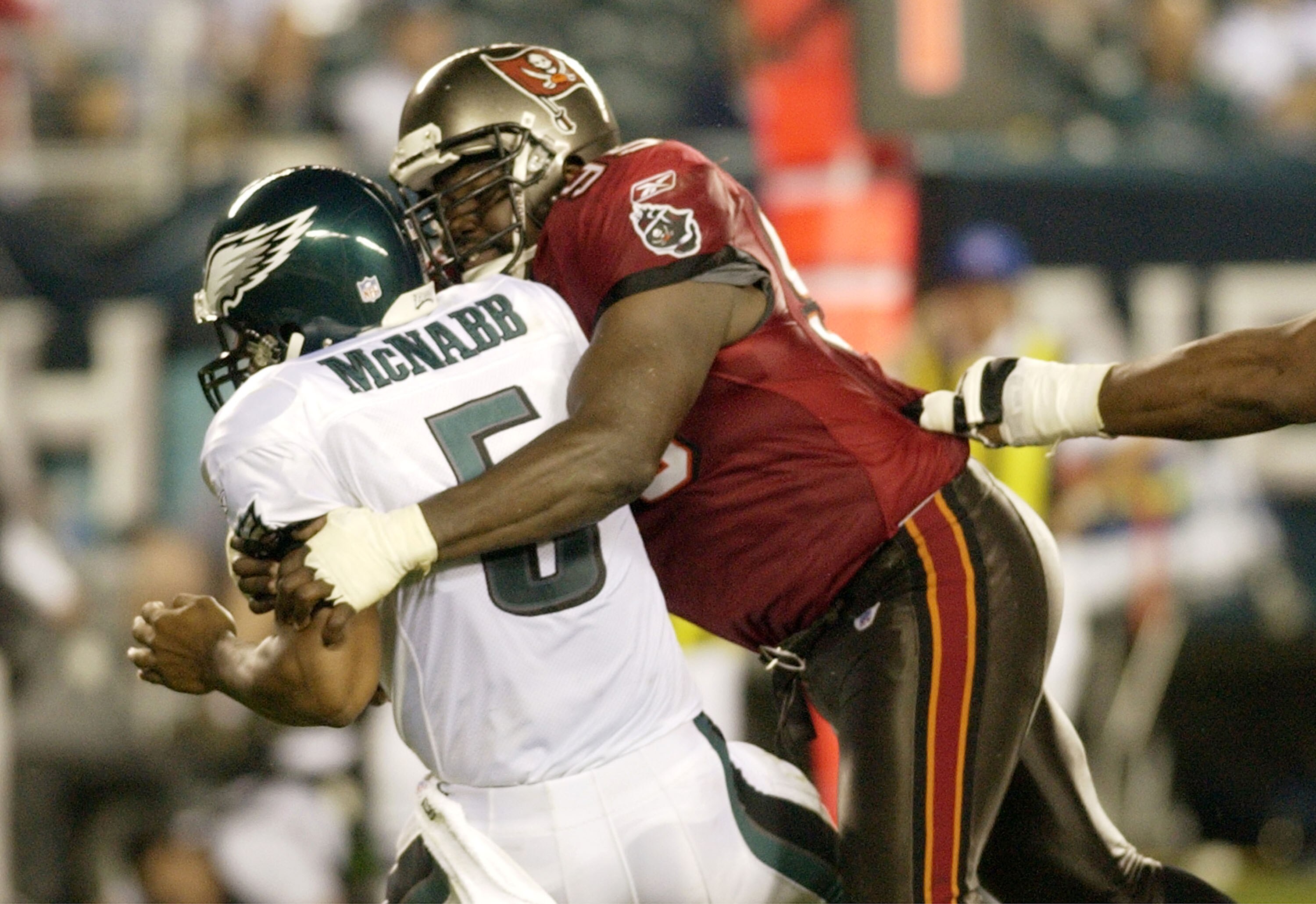 Tampa Bay Buccaneers defensive end  Warren Sapp pressures Philadelphia Eagles quarterback Donovan McNabb  September 8, 2003 at Lincoln Financial Field in Philadelphia.  The Bucs defeated the Eagles 17 - 0 to open the season on Monday Night football.  (Pho