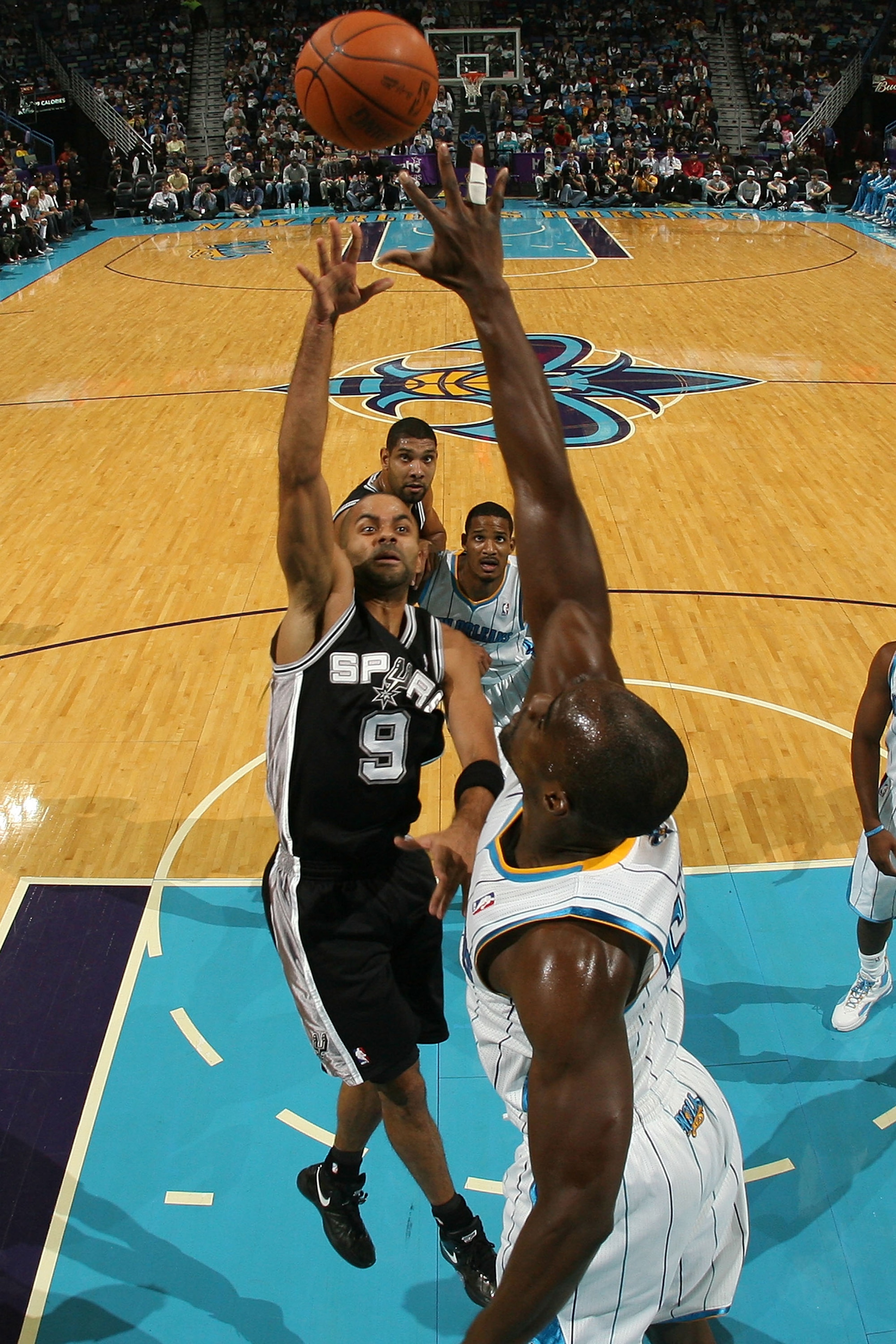NEW ORLEANS - NOVEMBER 28:  Tony Parker #9 of the San Antonio Spurs shoots the ball over Emeka Okafor #50 of the New Orleans Hornets at the New Orleans Arena on November 28, 2010 in New Orleans, Louisiana.  The Spurs defeated the Hornets 109-95.  NOTE TO