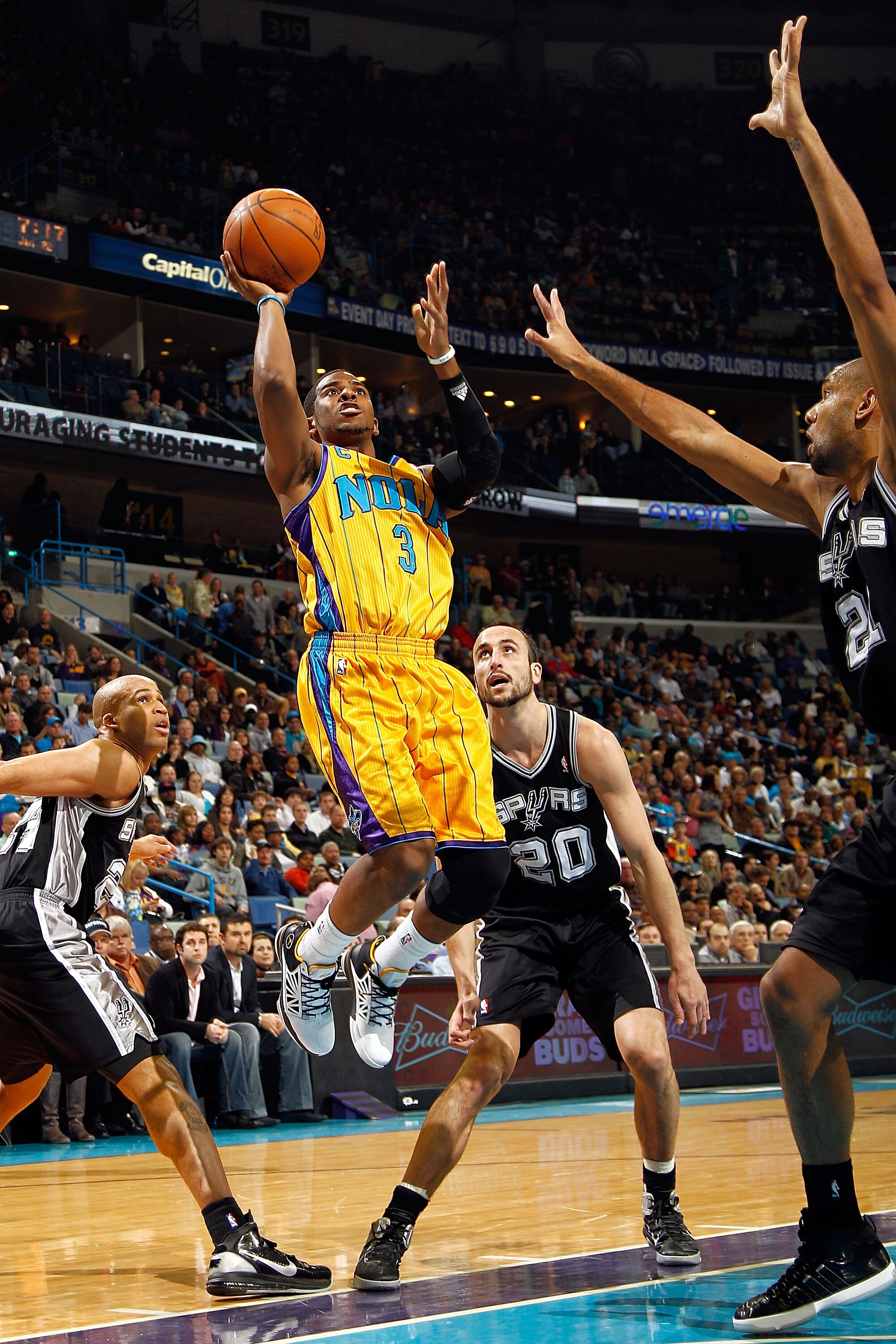 NEW ORLEANS, LA - JANUARY 22:  Chris Paul #3 of the New Orleans Hornets shoots the ball over Tim Duncan #21 of the San Antonio Spurs at the New Orleans Arena on January 22, 2011 in New Orleans, Louisiana.  NOTE TO USER: User expressly acknowledges and agr