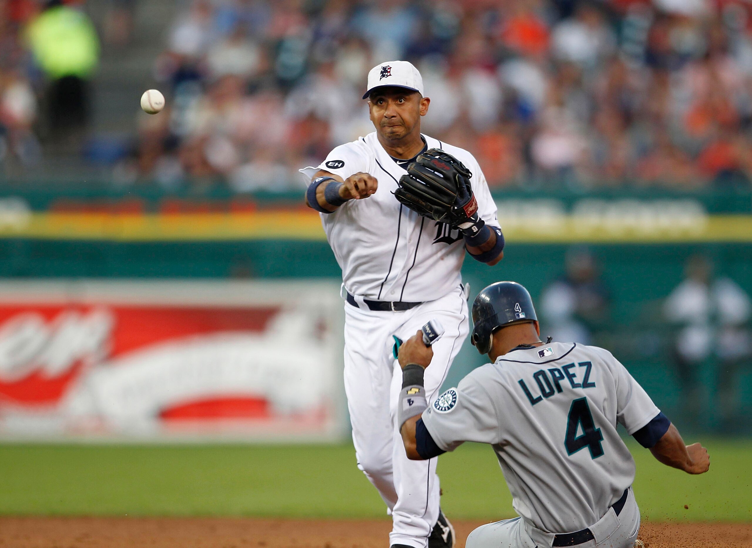 DETROIT - JULY 02: Carlos Guillen #9 of of the Detroit Tigers turns a double play forcing out Jose Lopez #4 of the Seattle Mariners at second base during the seventh inning of the game on July 2, 2010 at Comerica Park in Detroit, Michigan. The Tigers def DETROIT - JULY 02: Carlos Guillen #9 of of the Detroit Tigers turns a double play forcing out Jose Lopez #4 of the Seattle Mariners at second base during the seventh inning of the game on July 2, 2010 at Comerica Park in Detroit, Michigan. The Tigers def
