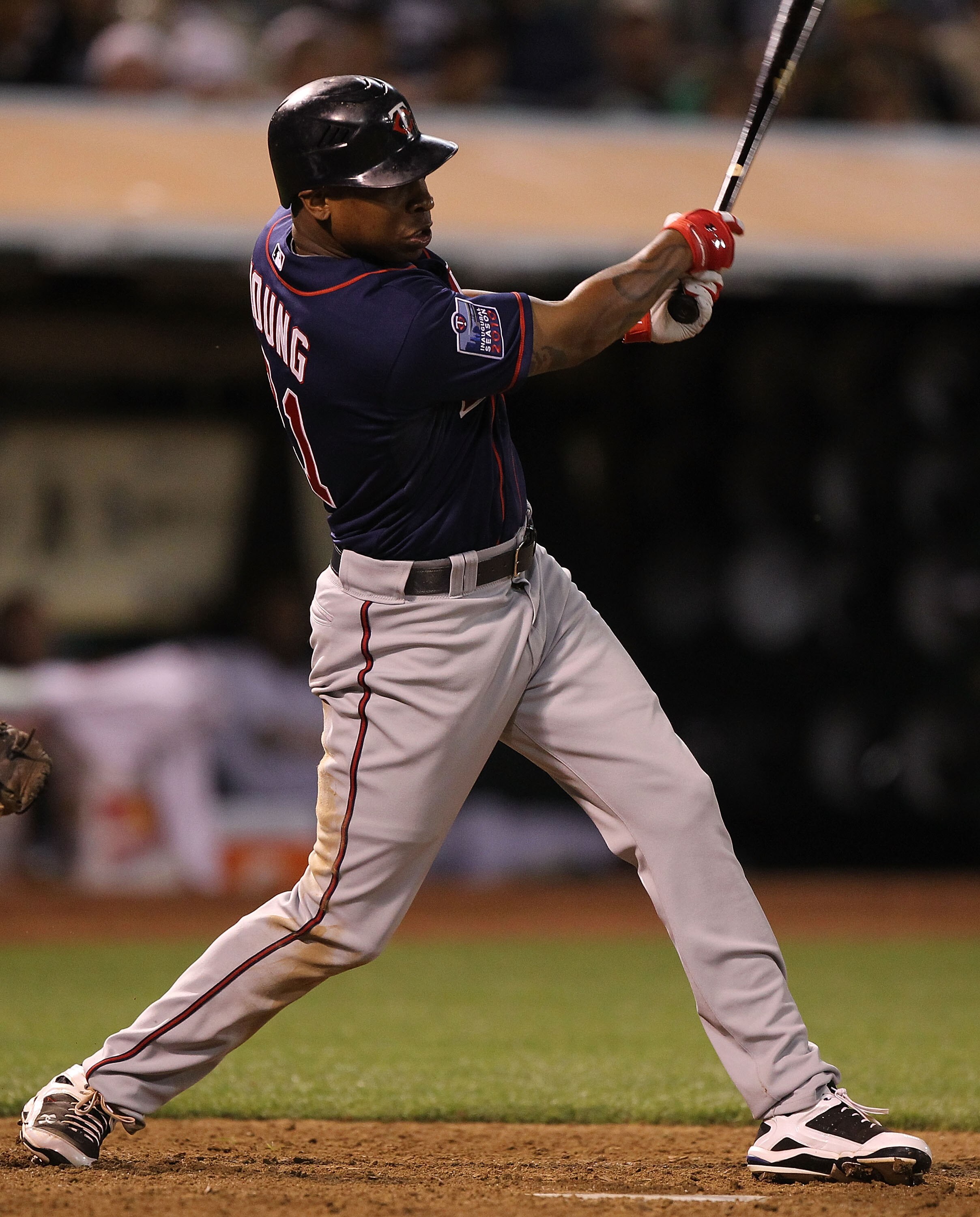 OAKLAND, CA - JUNE 4: Delmon Young #21 of the Minnesota Twins hits an RBI single in the eleventh inning against the Oakland Athletics during an MLB game at the Oakland-Alameda County Coliseum on June 4, 2010 in Oakland, California. (Photo by Jed Jacobsohn