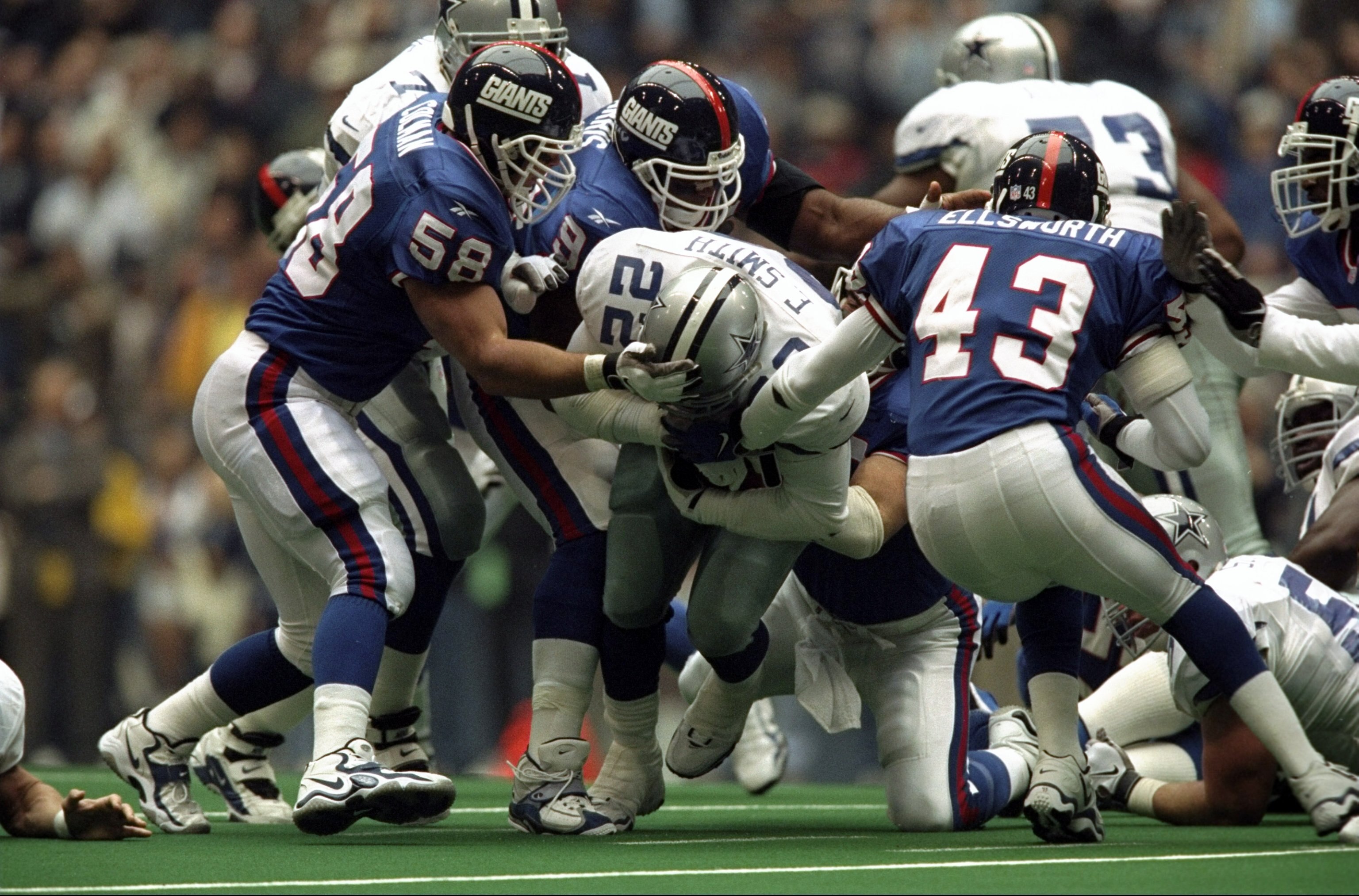 8 Nov 1998:  Emmitt Smith #22 of the Dallas Cowboys grips the ball as he is tackled during the game against the New York Giants at Texas Stadium in Irvine, Texas. The Cowboys defeated the Giants 16-6. Mandatory Credit: Stephen Dunn  /Allsport