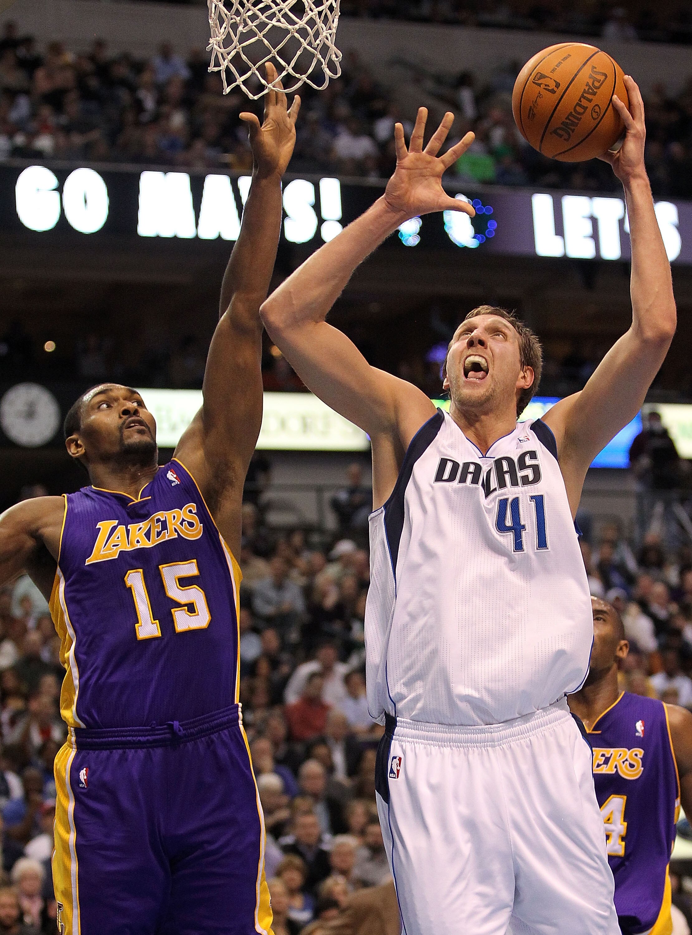 DALLAS, TX - JANUARY 19:  Forward Dirk Nowitzki #41 of the Dallas Mavericks takes a shot against Ron Artest #15 of the Los Angeles Lakers at American Airlines Center on January 19, 2011 in Dallas, Texas.  NOTE TO USER: User expressly acknowledges and agre