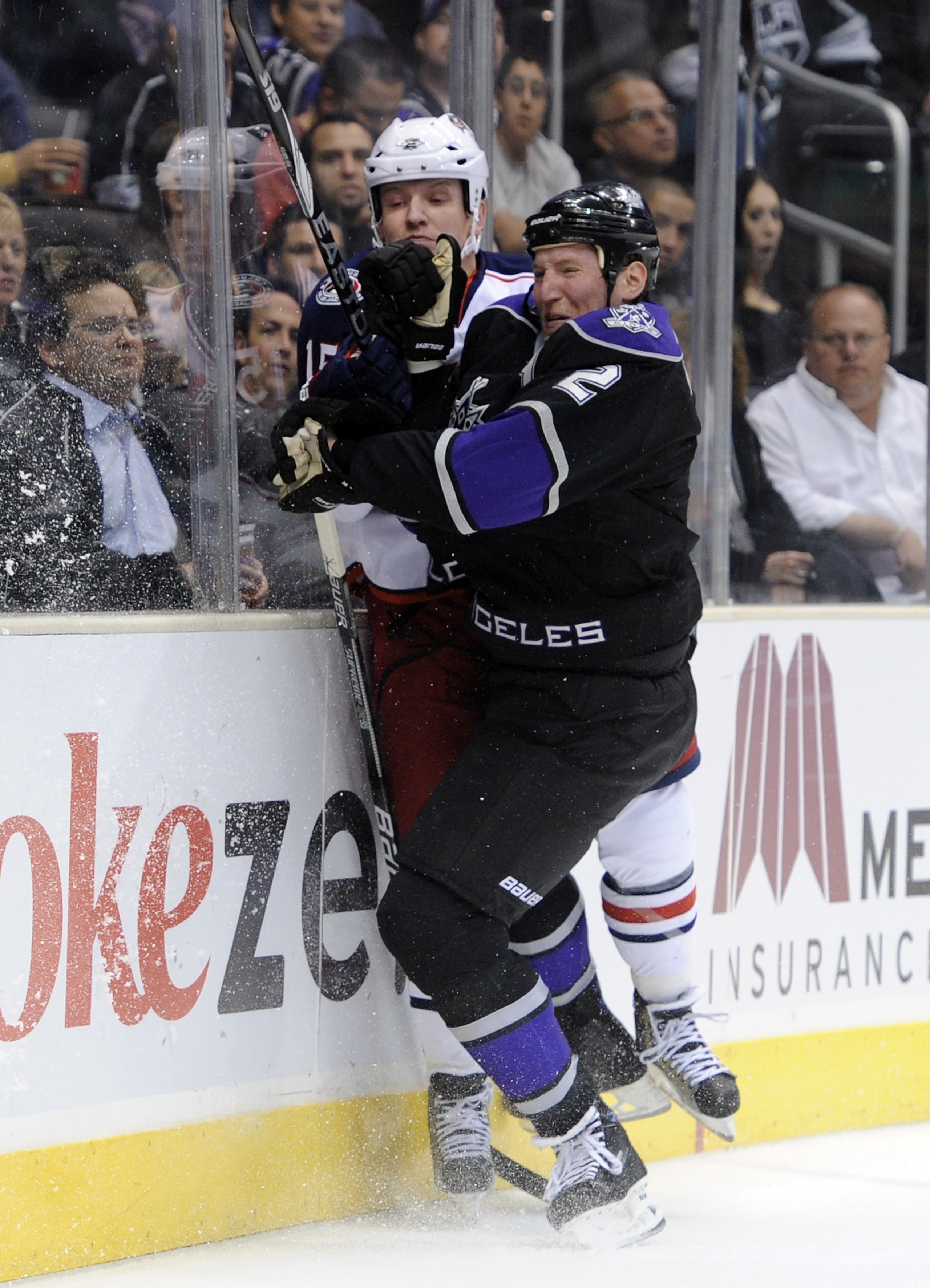 LOS ANGELES, CA - NOVEMBER 17:  Derek Dorsett #15 of the Columbus Blue Jackets takes a hit from Matt Greene #2 of the Los Angeles Kings during the first period at the Staples Center on November 17, 2010 in Los Angeles, California.  (Photo by Harry How/Get