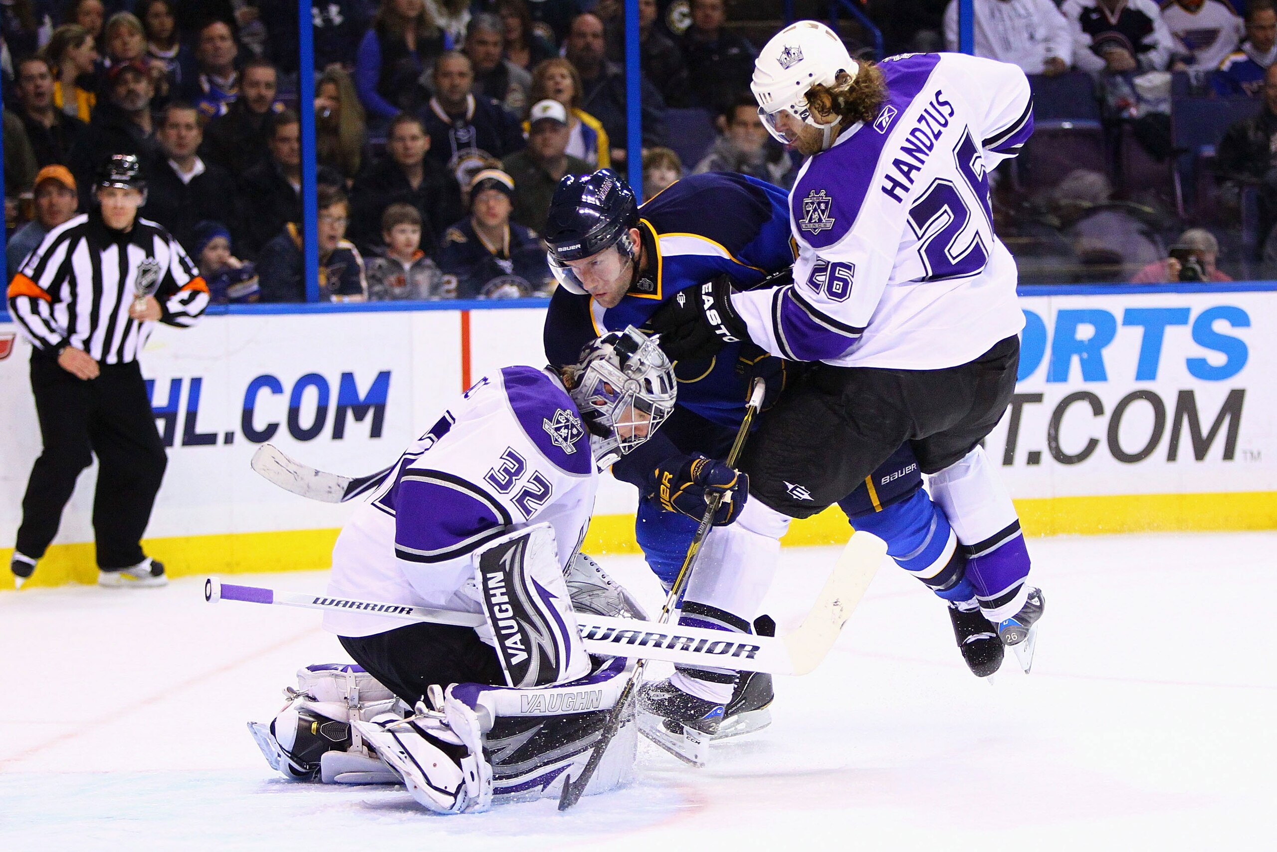 ST. LOUIS, MO - JANUARY 18: David Backes #42 of the St. Louis Blues is pushed into Jonathan Quick #32 of the Los Angeles Kings by Michal Handzus #26 of the Kings at the Scottrade Center on January 18, 2011 in St. Louis, Missouri.  (Photo by Dilip Vishwana