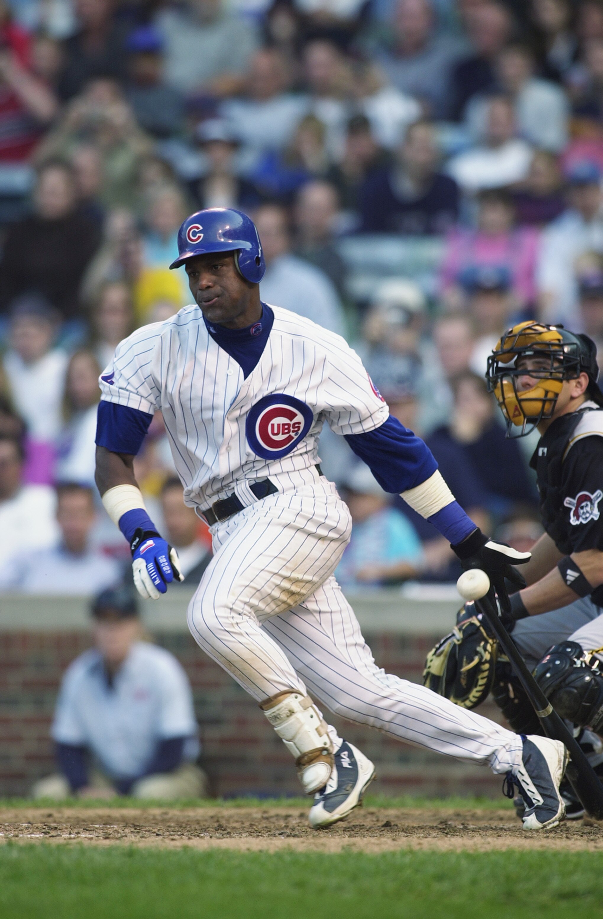 CHICAG0-SEPTEMBER 28:  Right fielder Sammy Sosa #21 of the Chicago Cubs makes contact with the ball and runs to first base during the game against the Pittsburgh Pirates on September 28, 2002 at Wrigley Field in Chicago, IL.  The Cubs defeated the Pirates