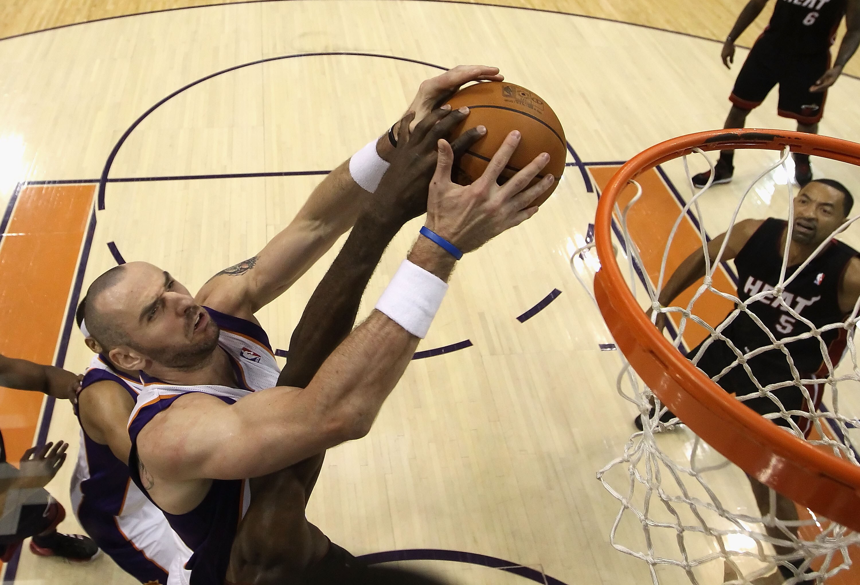 PHOENIX - DECEMBER 23:  Marcin Gortat #4 of the Phoenix Suns battles for a rebound against the Miami Heat during the NBA game at US Airways Center on December 23, 2010 in Phoenix, Arizona. The Heat defeated the Suns 95-83. NOTE TO USER: User expressly ack