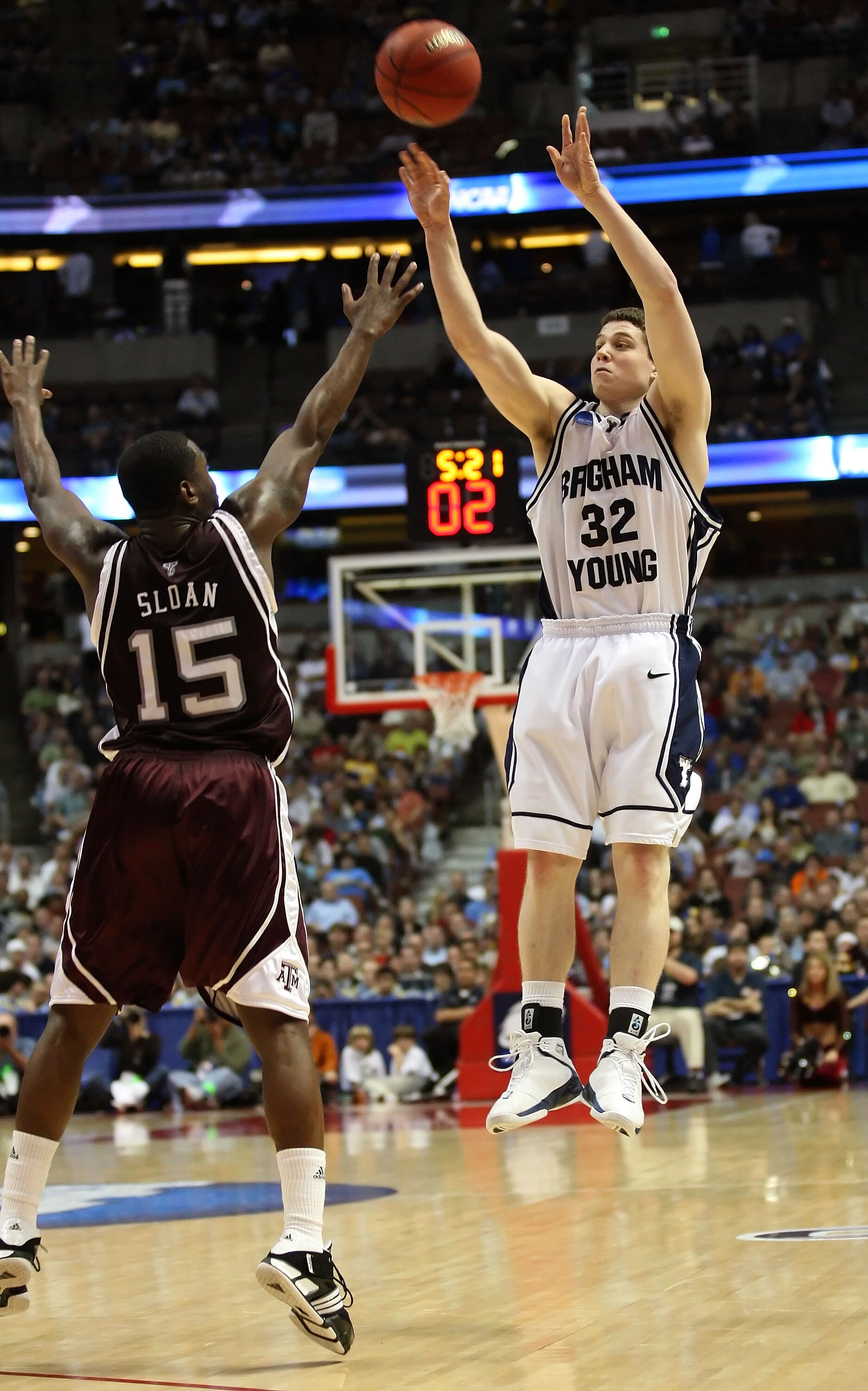 ANAHEIM, CA - MARCH 20:  Jimmer Fredette #32 of the Brigham Young Cougars shoots over the defense of Donald Sloan 315 of the Texas A&M Aggies during the West Region first round of the NCAA Basketball Tournament at the Honda Center on March 20, 2008 in Ana