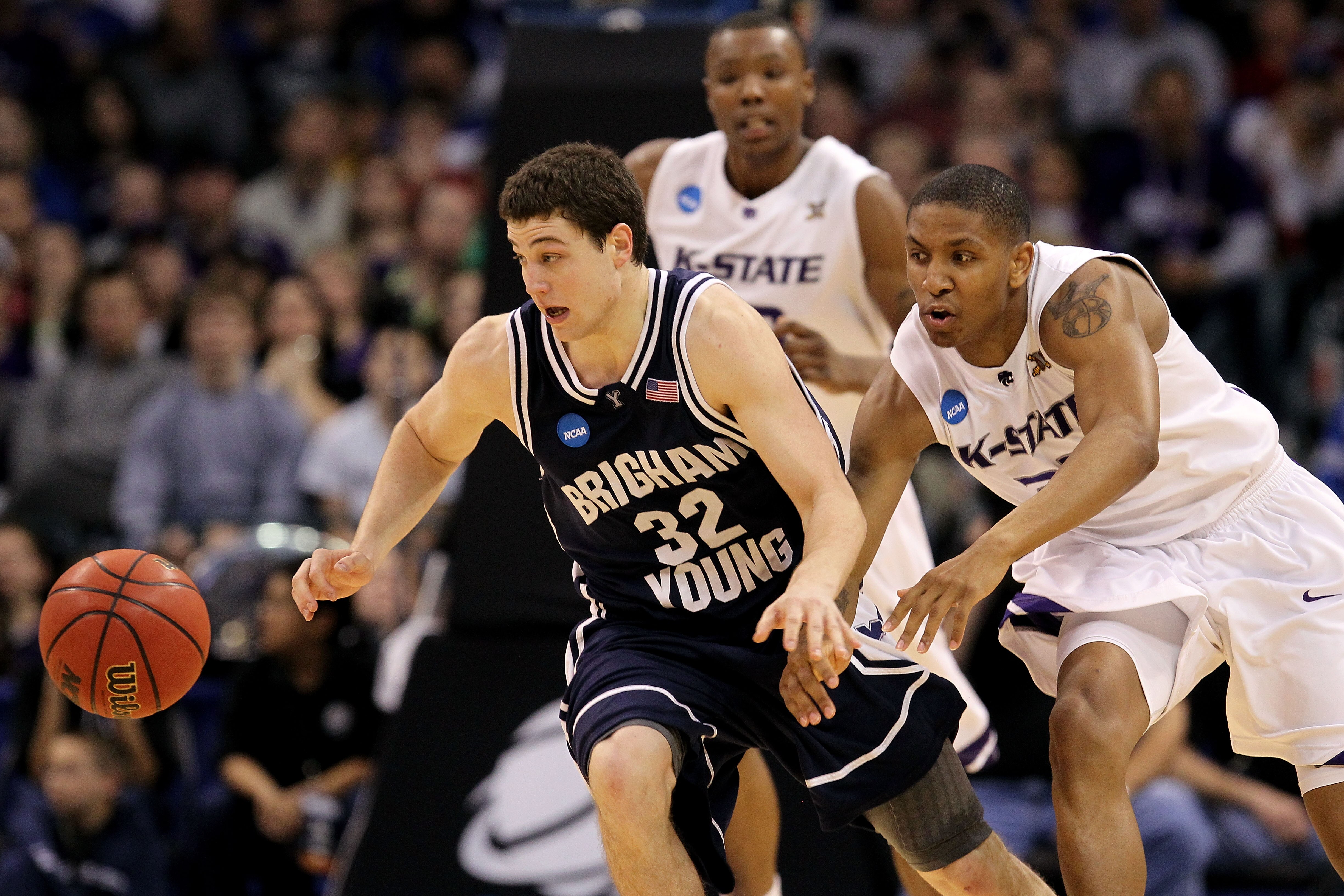 OKLAHOMA CITY - MARCH 20:  Jimmer Fredette #32 of the Brigham Young Cougars chases a loose ball against Rodney McGruder #22 of the Kansas State Wildcats during the second round of the 2010 NCAA men's basketball tournament at Ford Center on March 20, 2010