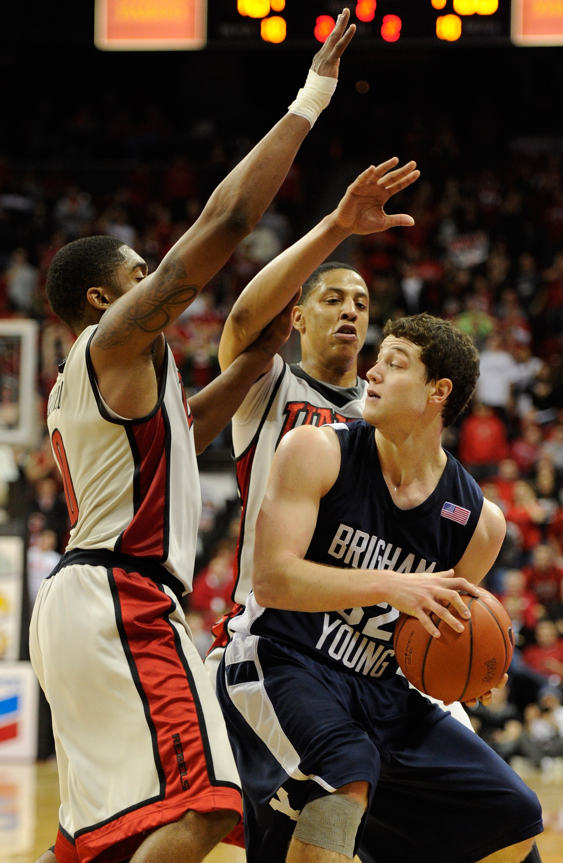 LAS VEGAS, NV - JANUARY 05:  Oscar Bellfield (L) #0 and Tre'Von Willis #33 of the UNLV Rebels try to trap Jimmer Fredette #32 of the Brigham Young University Cougars during their game at the Thomas & Mack Center January 5, 2011 in Las Vegas, Nevada. BYU w