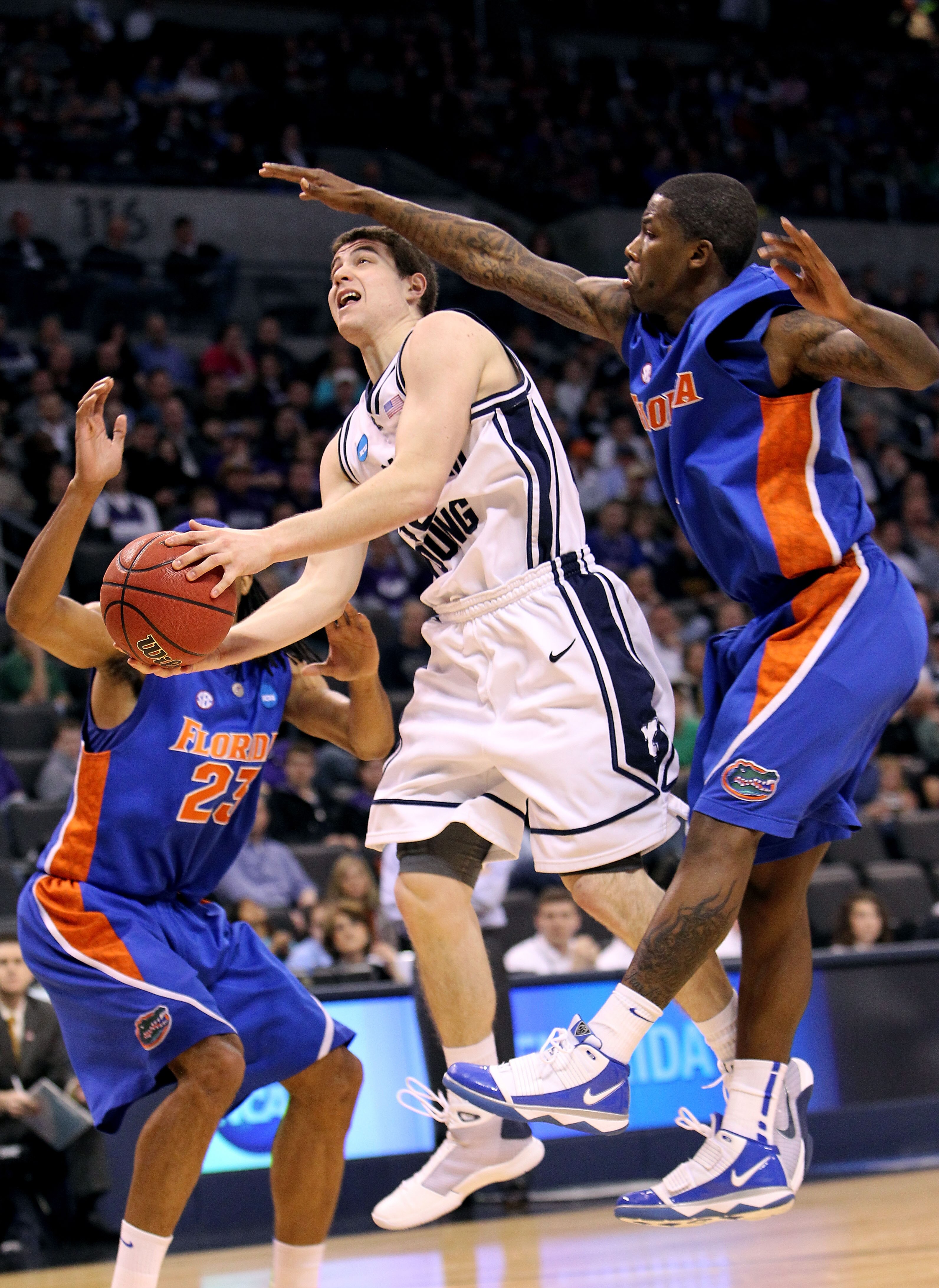 OKLAHOMA CITY - MARCH 18:  Jimmer Fredette #32 of the BYU Cougars drives for a shot attempt against Kenny Boynton #1 of the Florida Gators during the first round of the 2010 NCAA men?s basketball tournament at Ford Center on March 18, 2010 in Oklahoma Cit