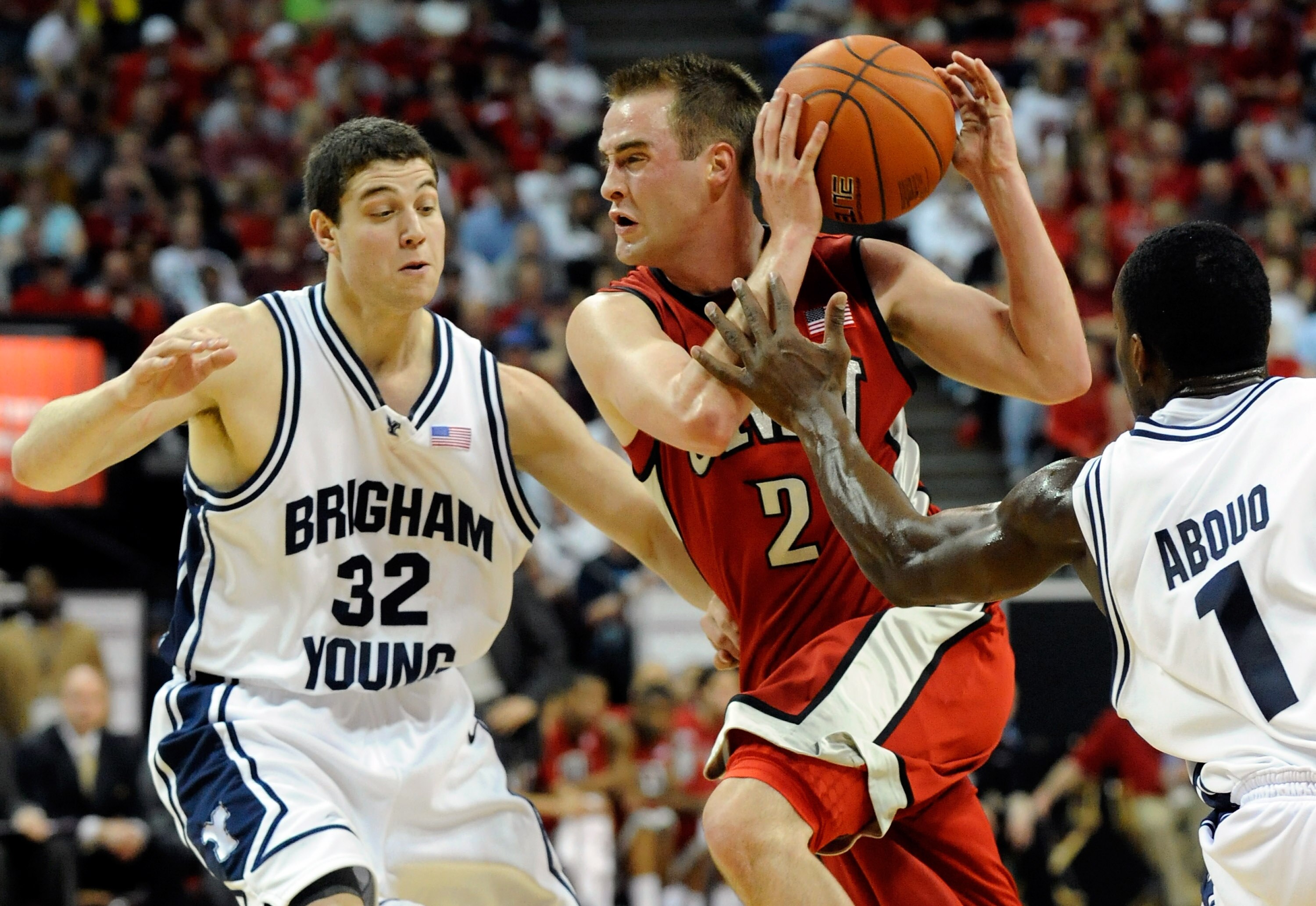LAS VEGAS - MARCH 12: Kendall Wallace #2 of the UNLV Rebels drives between Jimmer Fredette #32 and Charles Abouo #1 of the Brigham Young University Cougars during a semifinal game of the Conoco Mountain West Conference Basketball tournament at the Thomas