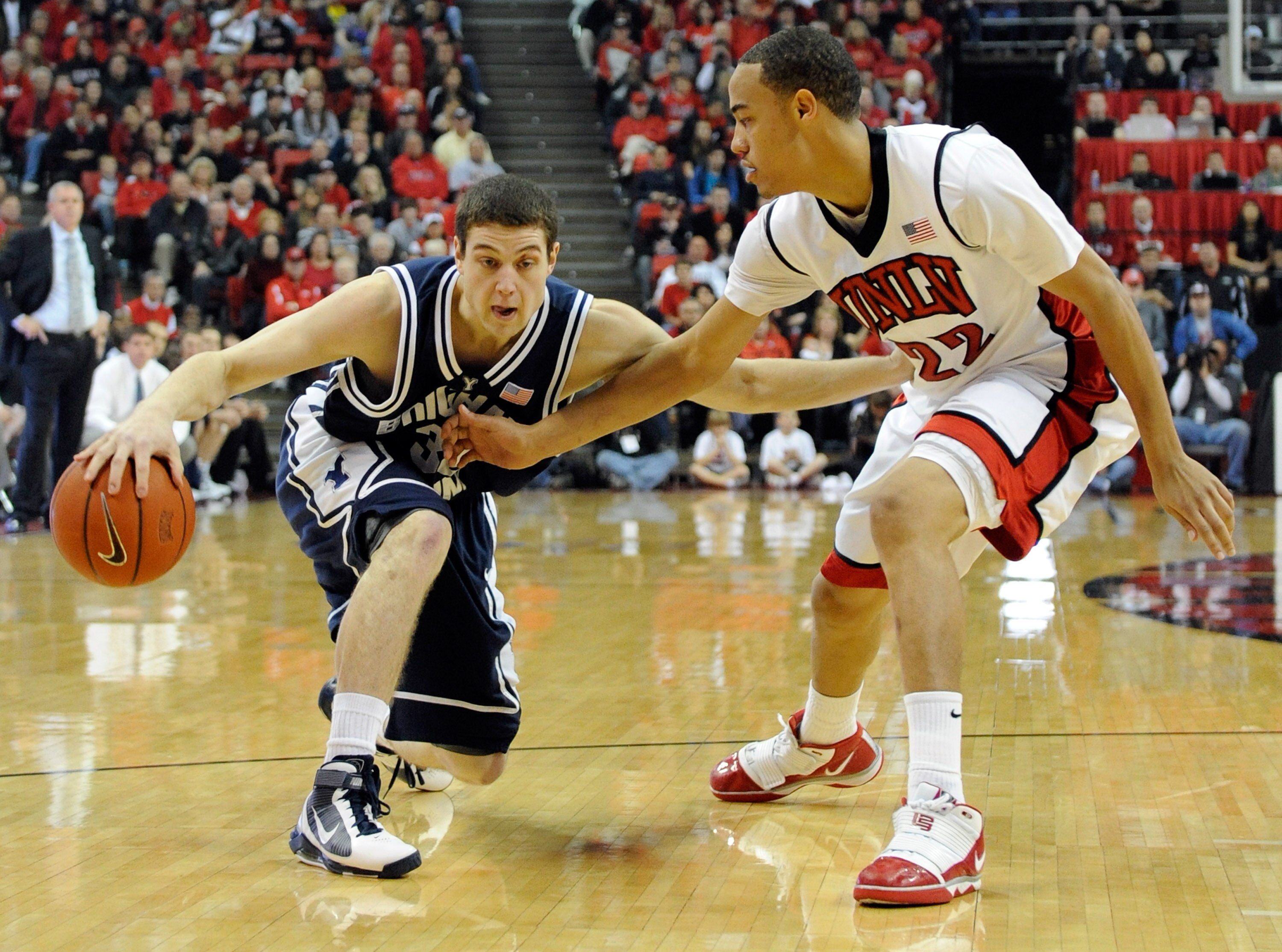 LAS VEGAS - FEBRUARY 06:  Jimmer Fredette #32 of the Brigham Young University Cougars drives against Chace Stanback #22 of the UNLV Rebels during their game at the Thomas & Mack Center February 6, 2010 in Las Vegas, Nevada.  (Photo by Ethan Miller/Getty I