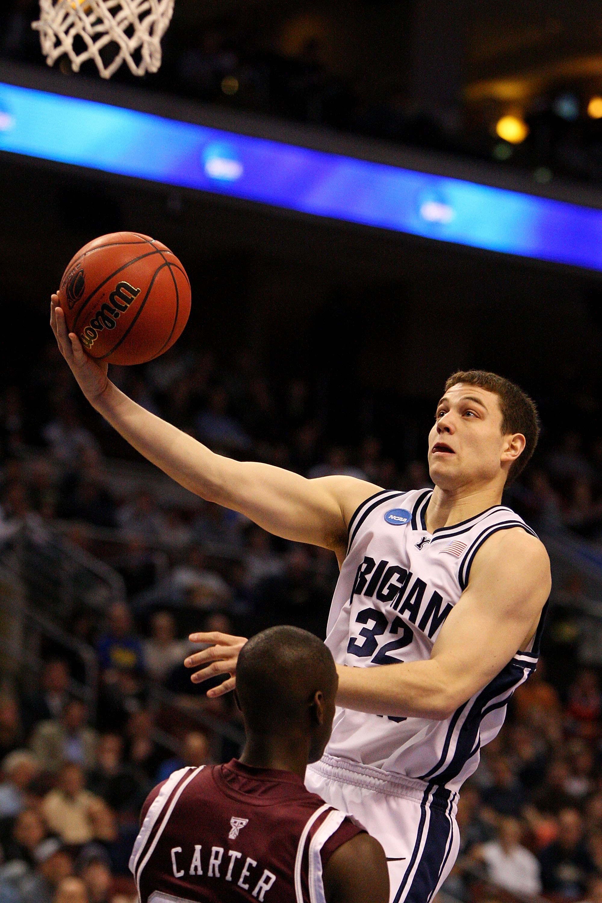 PHILADELPHIA - MARCH 19:  Jimmer Fredette #32 of the Brigham Young Cougars shoots against Josh Carter #23 of the Texas A&M Aggies during the first round of the NCAA Division I Men's Basketball Tournament at the Wachovia Center on March 19, 2009 in Philade