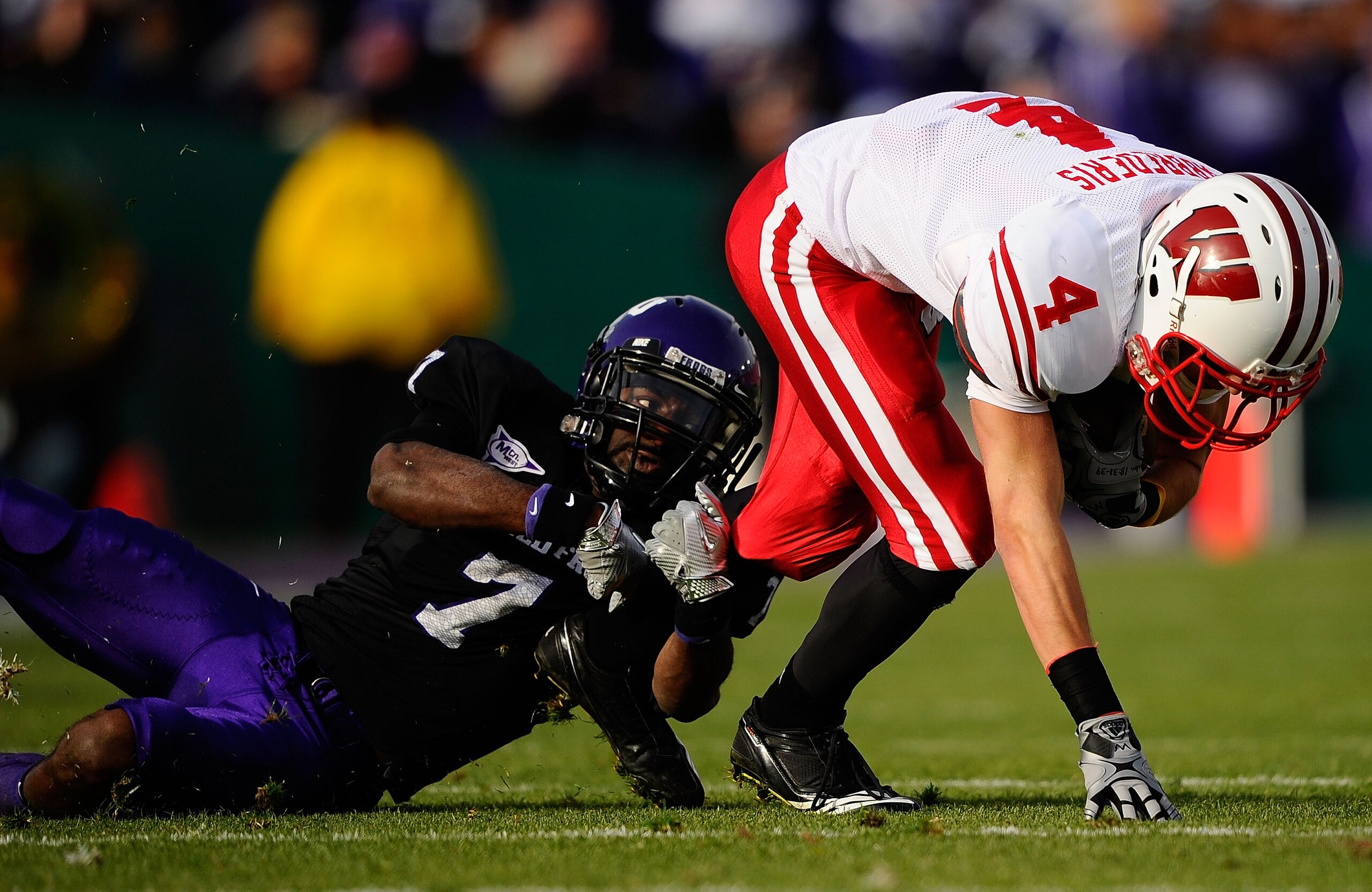 PASADENA, CA - JANUARY 01:  Wide receiver Jared Abbrederis #4 of the Wisconsin Badgers is tackled by cornerback Greg McCoy #7 of the TCU Horned Frogs during the 97th Rose Bowl game on January 1, 2011 in Pasadena, California.  (Photo by Kevork Djansezian/G