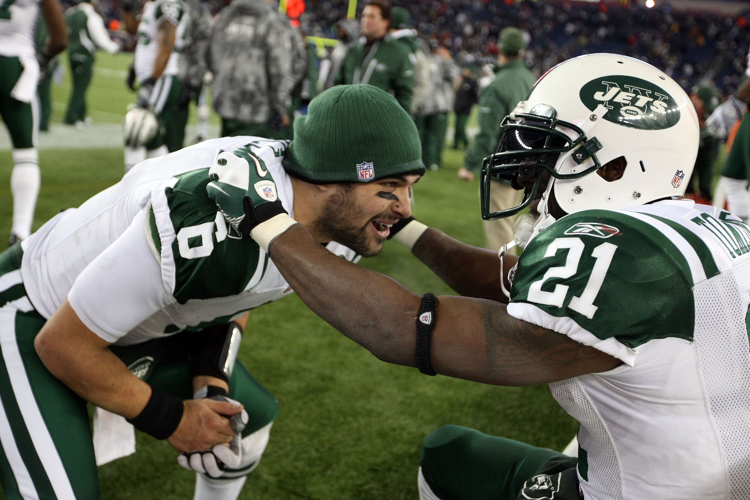 FOXBORO, MA - JANUARY 16: Mark Sanchez #6 and LaDainian Tomlinson #21 of the New York Jets celebrate after the Jets defeated the Patriots 28 to 21 in their 2011 AFC divisional playoff game at Gillette Stadium on January 16, 2011 in Foxboro, Massachusetts.