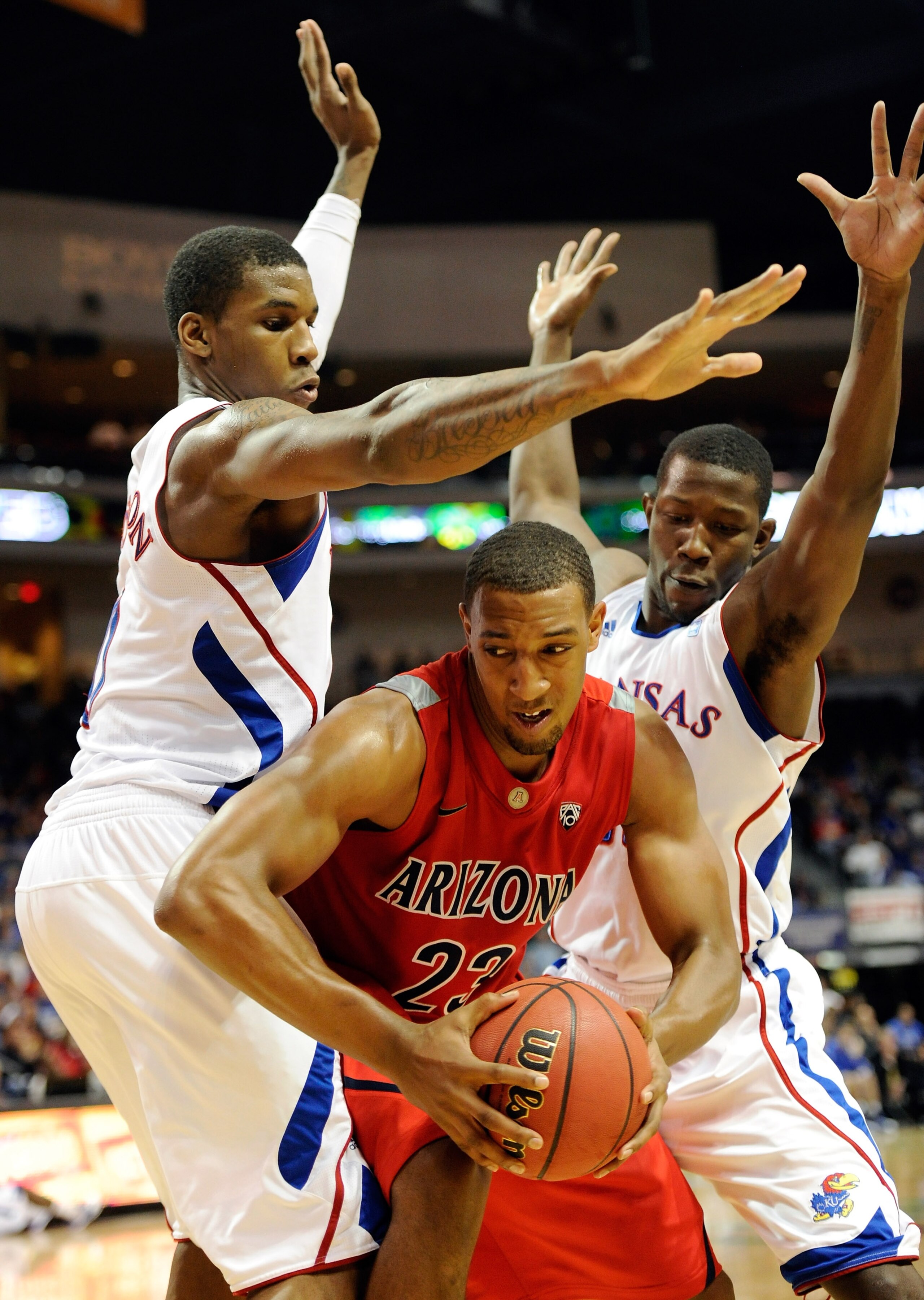 LAS VEGAS - NOVEMBER 27: Derrick Williams #23 of the Arizona Wildcats drives between Thomas Robinson (L) #0 and Mario Little #23 of the Kansas Jayhawks during the championship game of the Las Vegas Invitational at The Orleans Arena November 27, 2010 in L LAS VEGAS - NOVEMBER 27: Derrick Williams #23 of the Arizona Wildcats drives between Thomas Robinson (L) #0 and Mario Little #23 of the Kansas Jayhawks during the championship game of the Las Vegas Invitational at The Orleans Arena November 27, 2010 in L