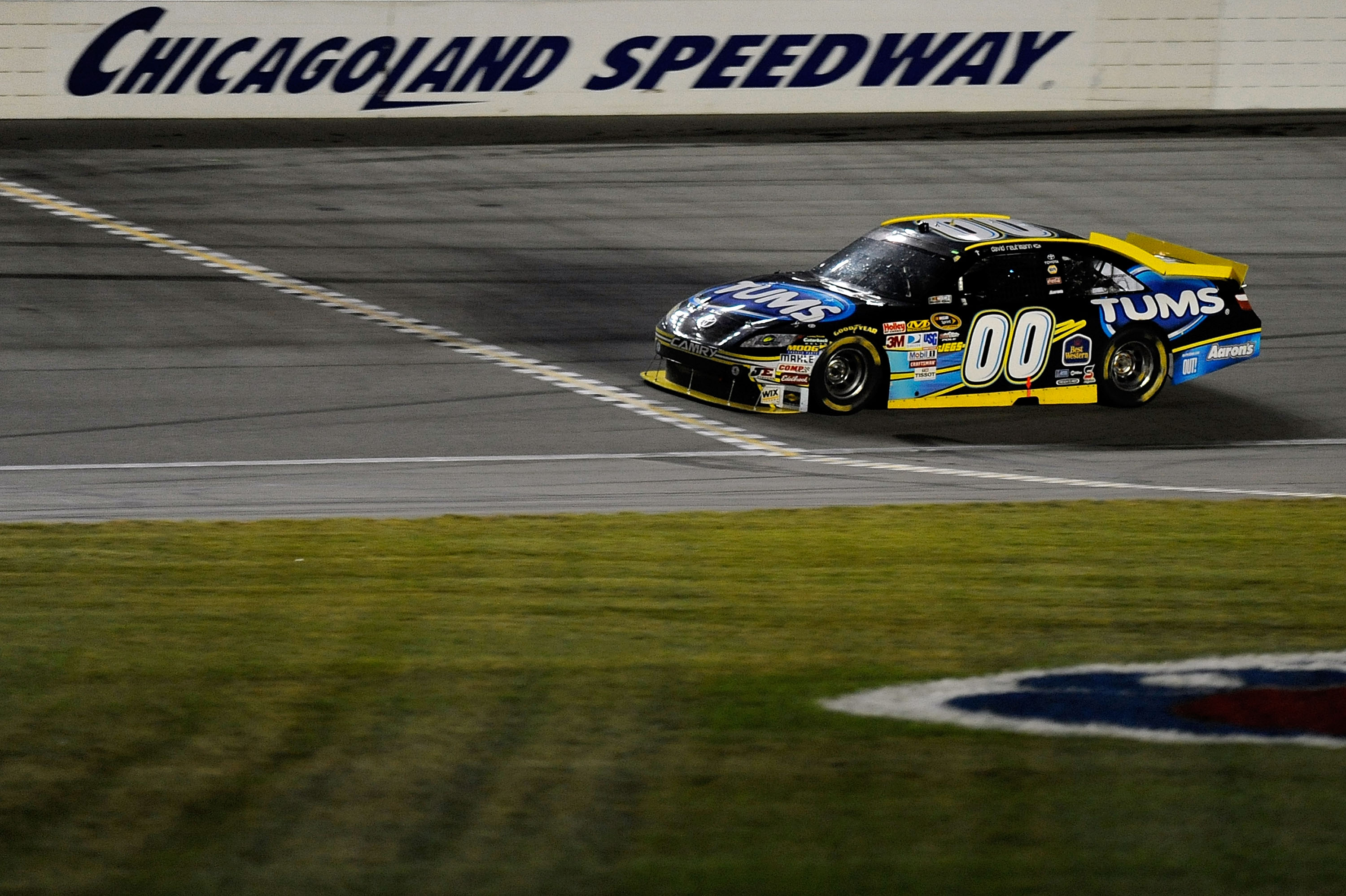 JOLIET, IL - JULY 10:  David Reutimann, driver of the #00 TUMS Toyota, heads across the start/finish line to take the checkered flag and win the NASCAR Sprint Cup Series LIFELOCK.COM 400 at the Chicagoland Speedway on July 10, 2010 in Joliet, Illinois.  (
