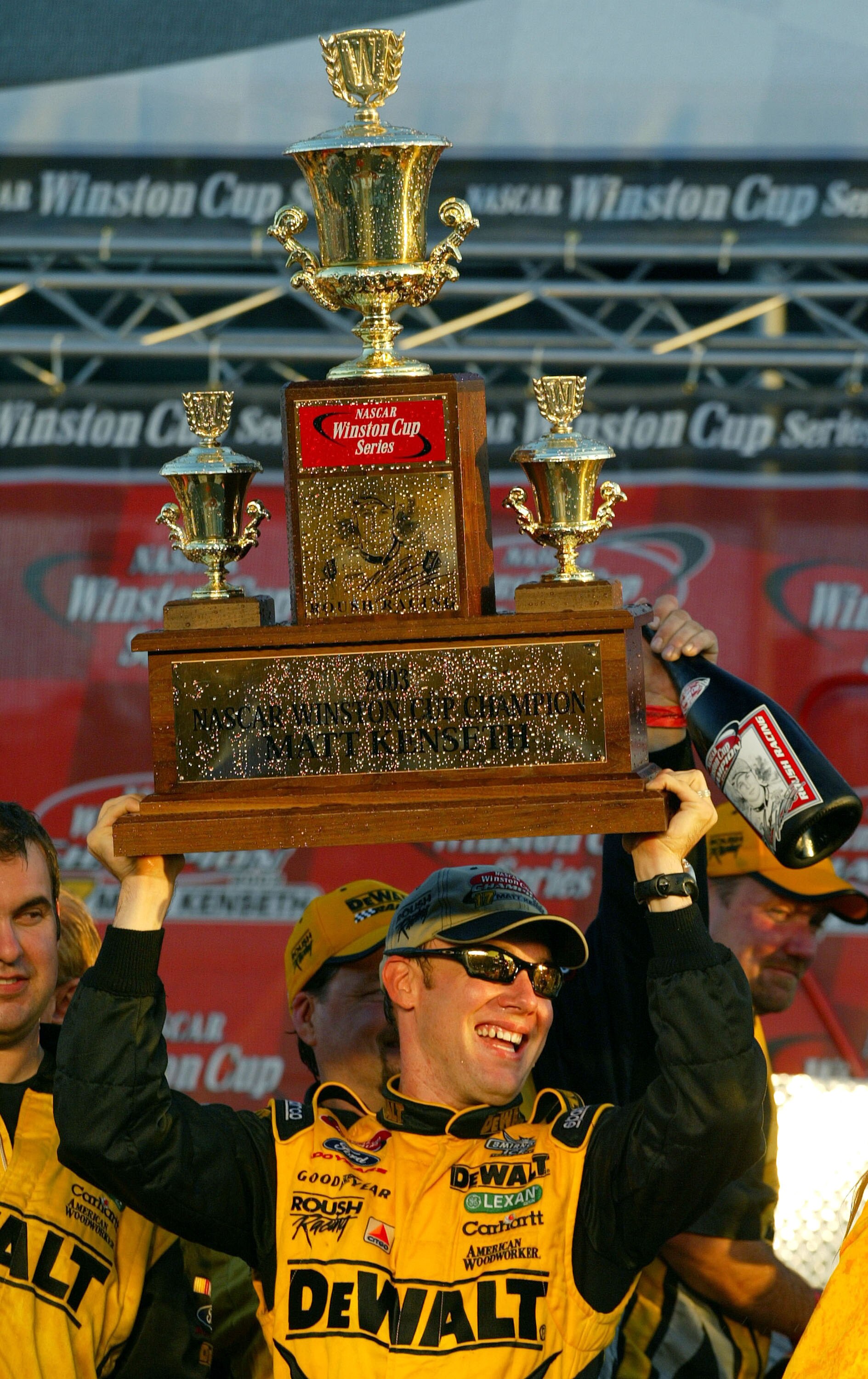 HOMESTEAD, FL - NOVEMBER 16:  Matt Kenseth driver of the #17 Roush Racing DeWalt Power Tools Ford lifts the Champioship Trophy to celebrate winning the NASCAR Winston Cup Championship after the Ford 400 at the Homestead-Miami Speedway on November16, 2003