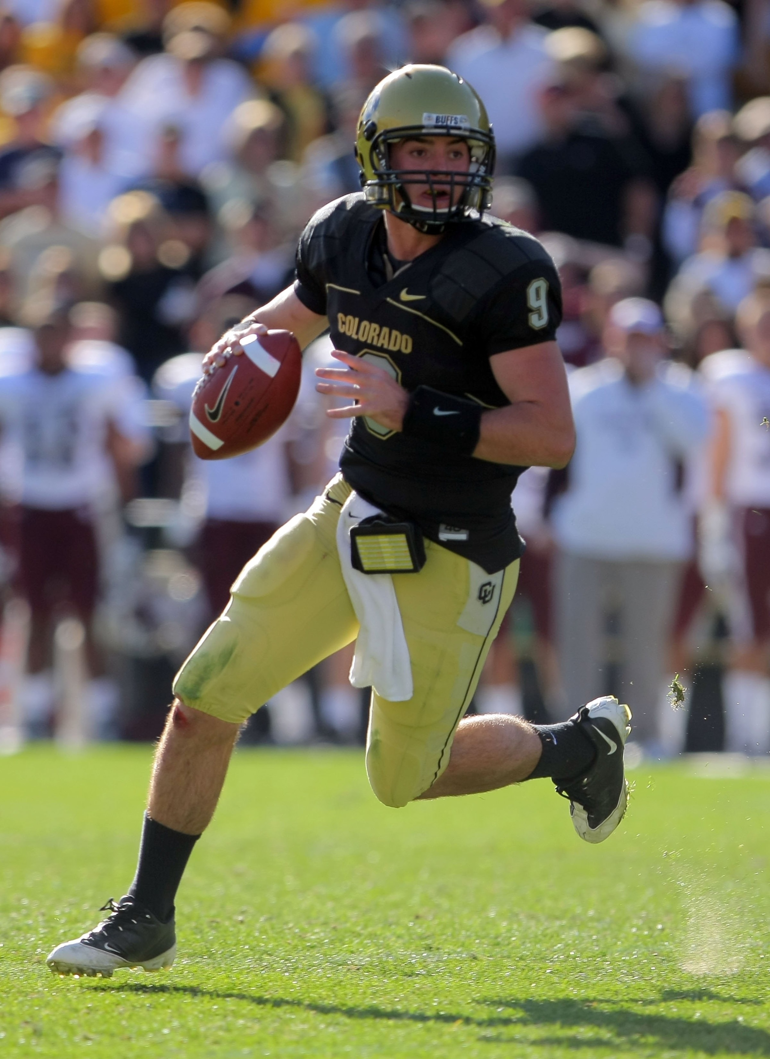 BOULDER, CO - NOVEMBER 07:  Quarterback Tyler Hansen #9 of the Colorado Buffaloes rolls out to deliver a pass against the Texas A&M Aggies during NCAA college football action at Folsom Field on November 7, 2009 in Boulder, Colorado. Colorado defeated Texa