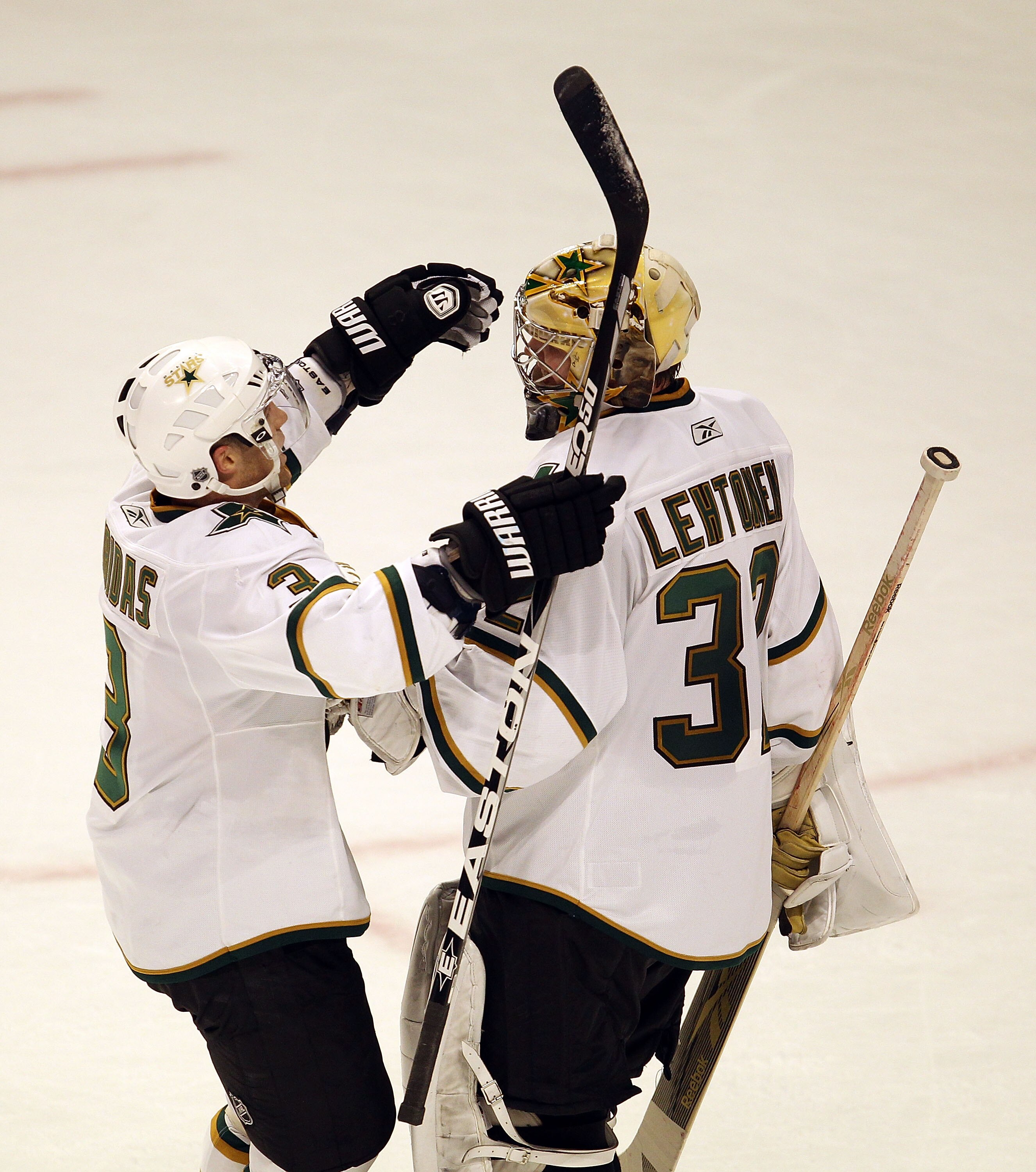 CHICAGO, IL - JANUARY 05: Stephane Robidas #3 of the Dallas Stars hugs teammate Kari Lehtonen #32 after a win over the Chicago Blackhawks at the United Center on January 5, 2011 in Chicago, Illinois. The Stars defeated the Blackhawks 4-2. (Photo by Jonath