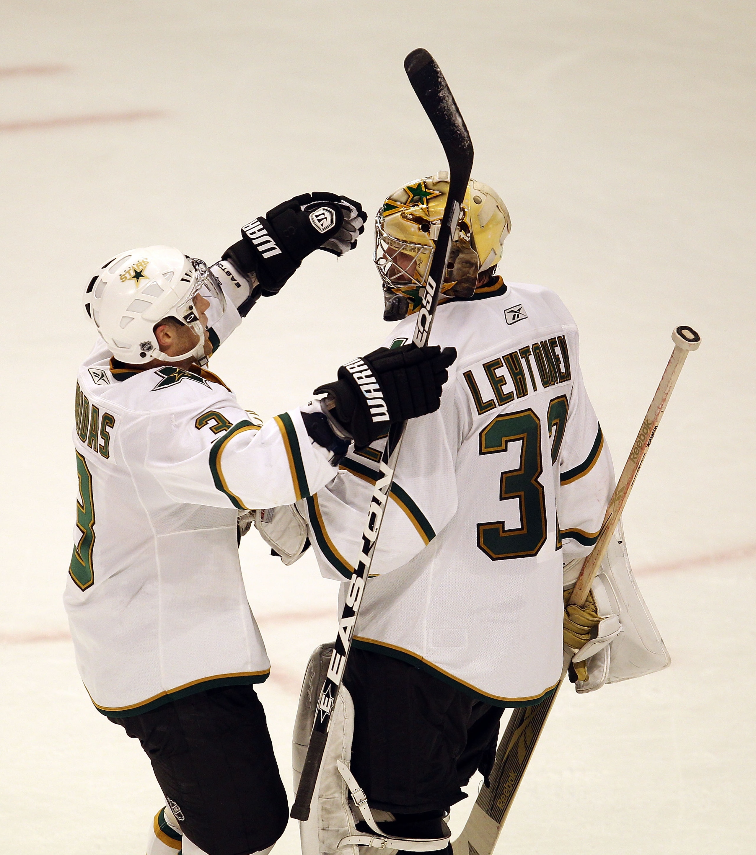 CHICAGO, IL - JANUARY 05: Stephane Robidas #3 of the Dallas Stars hugs teammate Kari Lehtonen #32 after a win over the Chicago Blackhawks at the United Center on January 5, 2011 in Chicago, Illinois. The Stars defeated the Blackhawks 4-2. (Photo by Jonath