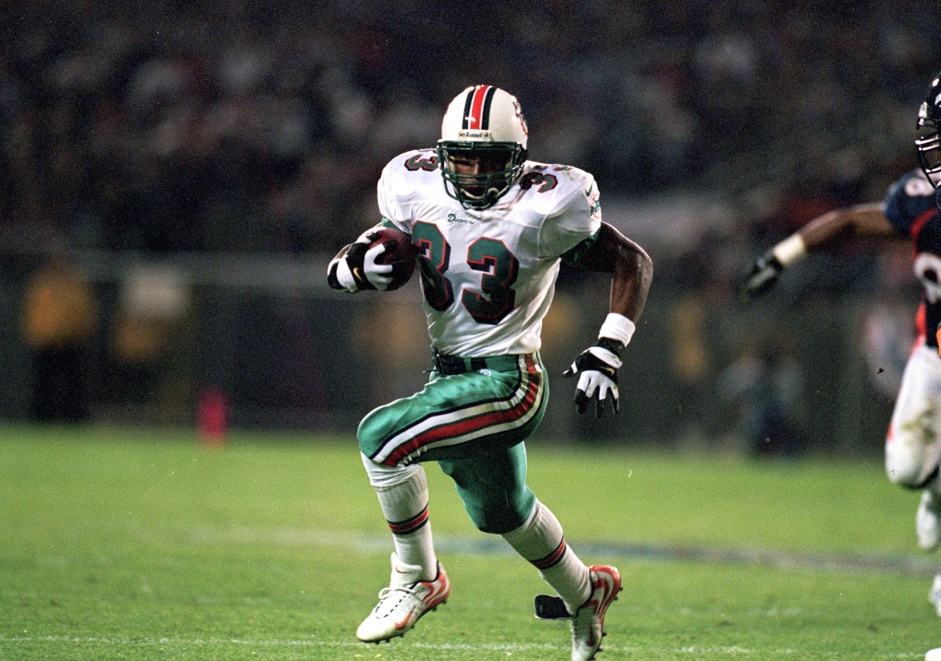 13 Sep 1999: Karim Abdul-Jabbar #33 of the Miami Dolphins carries the ball during a game against the Denver Broncos at the Mile High Stadium in Denver, Colorado. The Dolphins defeated the Broncos 38-21. Mandatory Credit: Brian Bahr  /Allsport