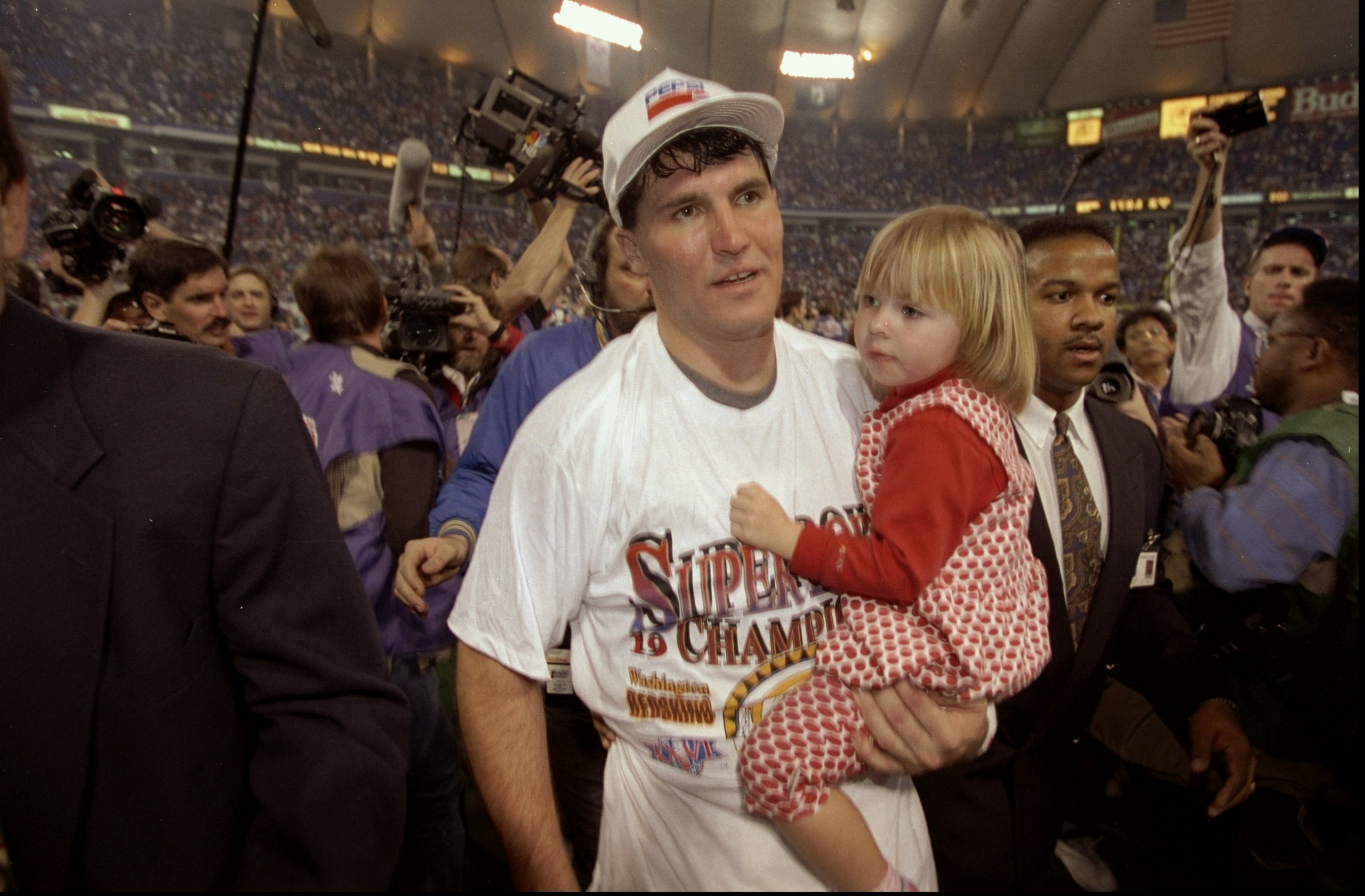 Jan 26, 1992:  Quarterback Mark Rypien of the Washington Redskins holds his daughter after Super Bowl XXVI against the Buffalo Bills at the Hubert Humphrey Metrodome in Minneapolis, Minnesota.  The Redskins defeated the Bills 37-24. Mandatory Credit: Rick